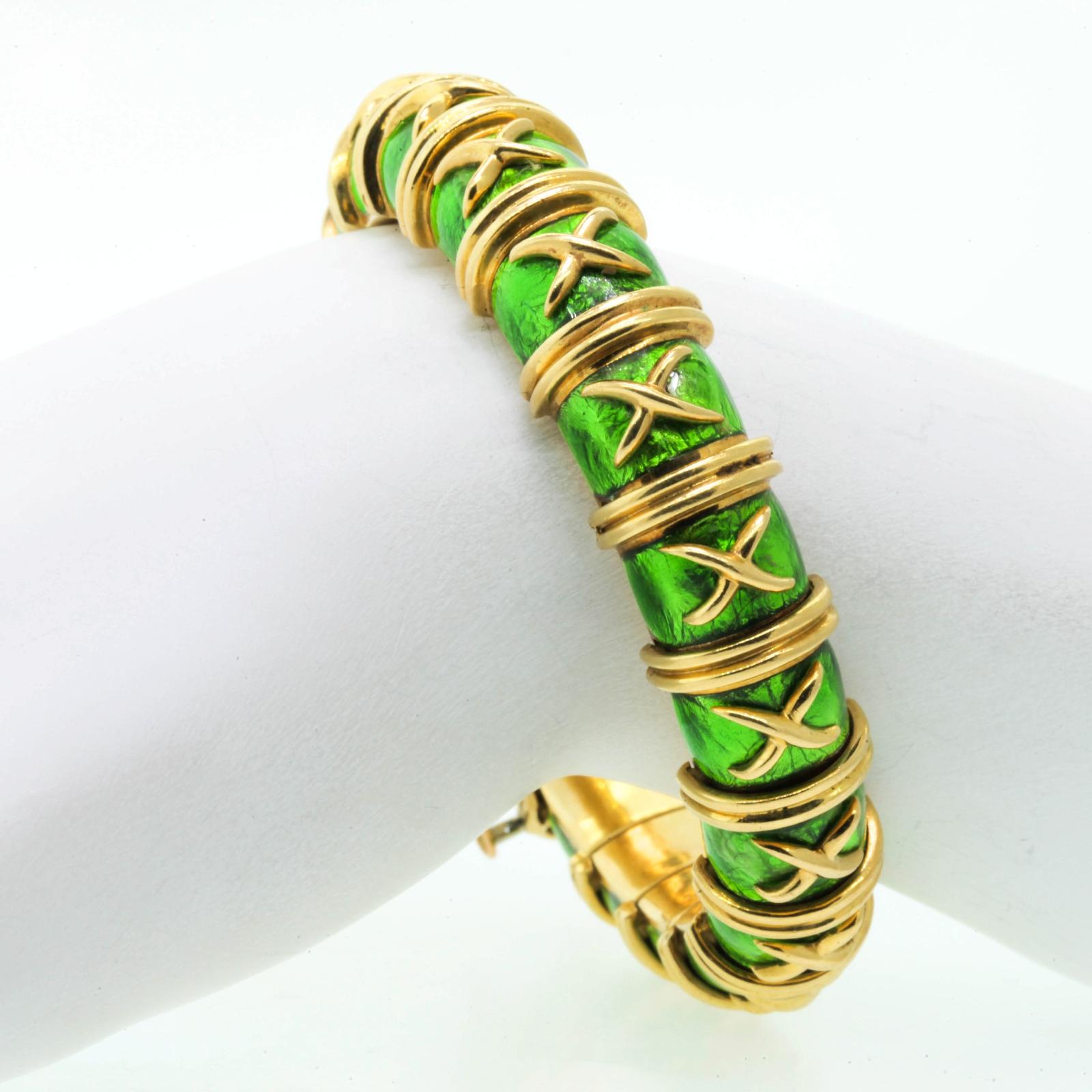Always iconic Tiffany & Co. Schlumberger Croissillon 18KT yellow gold bracelet of Paillone peridot green enamel.  The bracelet measures 6 3/8 inches in diameter - to fit a 6.5 medium wrist.  Made in France with French hallmarks.  For the connoisseur