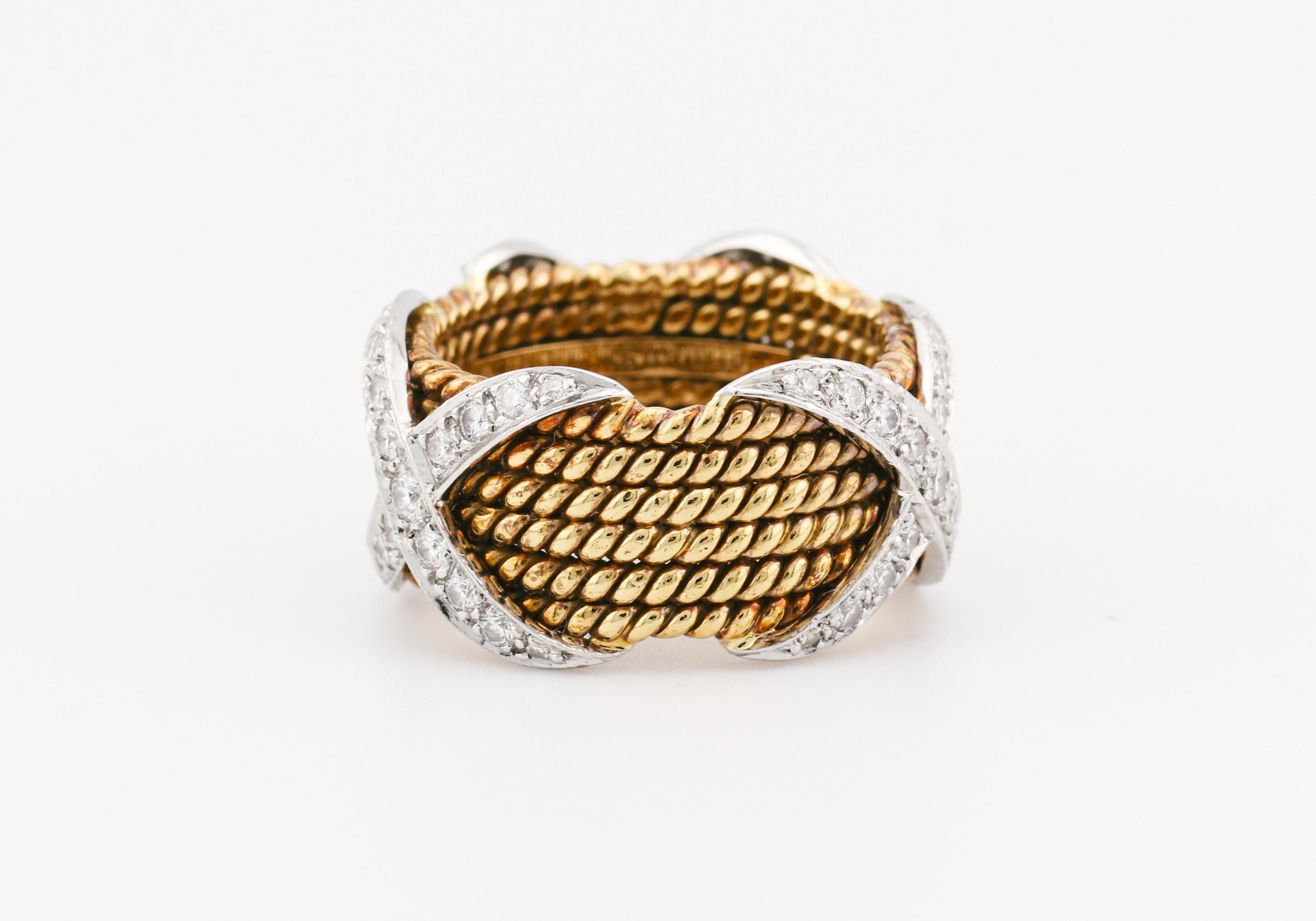 Introducing the Tiffany & Co. Schlumberger 18K Yellow Gold 6-Row Rope Design Ring with Platinum X's Adorned with Diamonds—a masterpiece that harmoniously blends classic artistry with modern elegance. Crafted by the legendary collaboration between