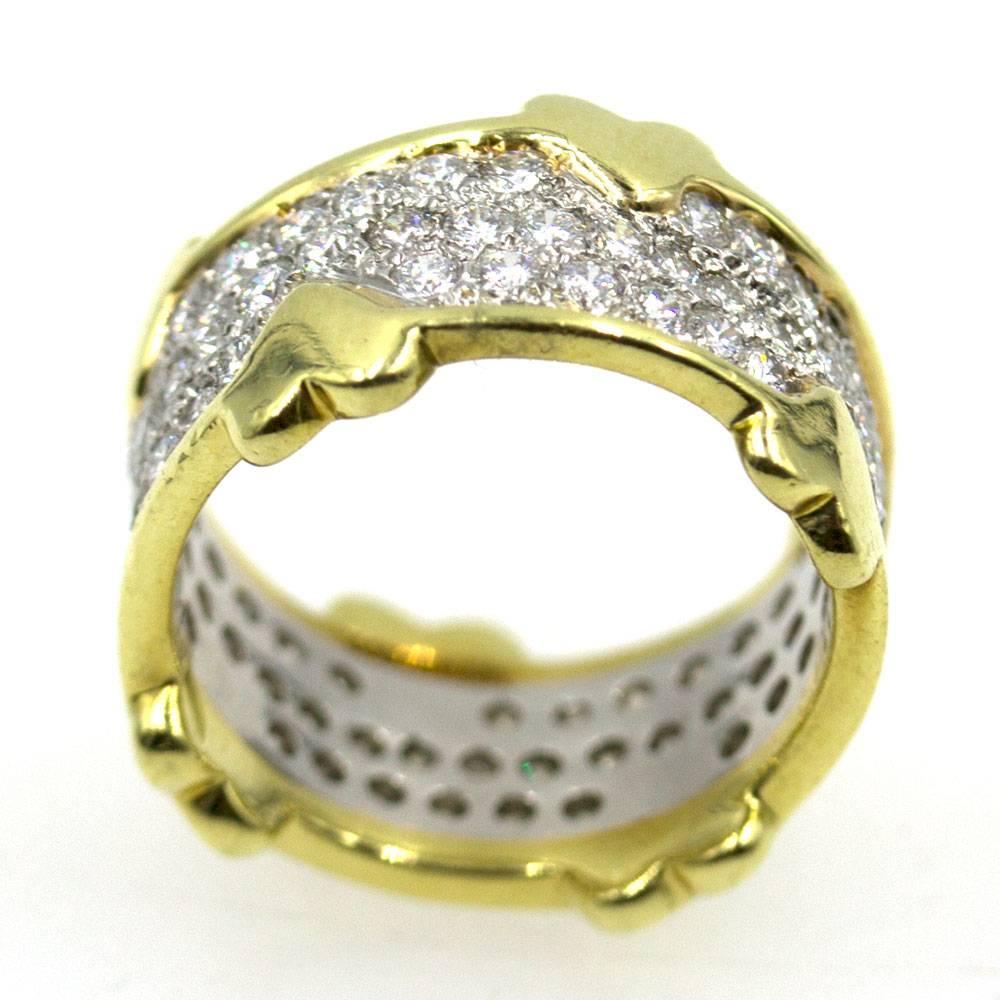 This fabulous diamond band by Jean Schlumberger for Tiffany & Co. is fashioned in 18 karat yellow gold and platinum. The 2.40 carat of round brilliant cut diamonds are set in platinum, while the heart edge is crafted in 18 karat yellow gold. The