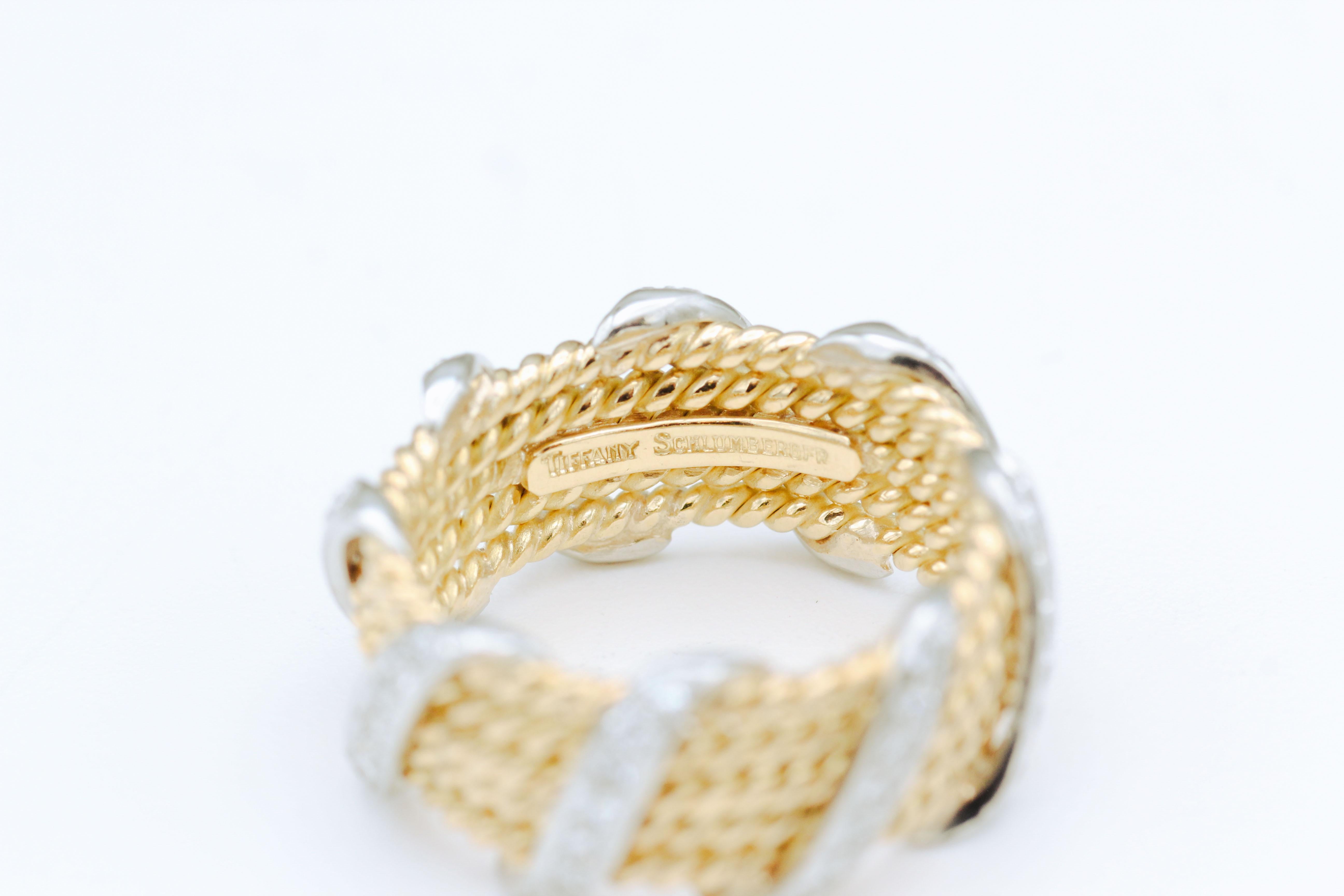 Fine platinum and 18K yellow gold diamond  band by Tiffany & Co., Schlumberger.  The band has five rows and features high quality brilliant cut diamonds.  Approx. size 7. 

Hallmarks: Tiffany & Co., Schlumberger.
