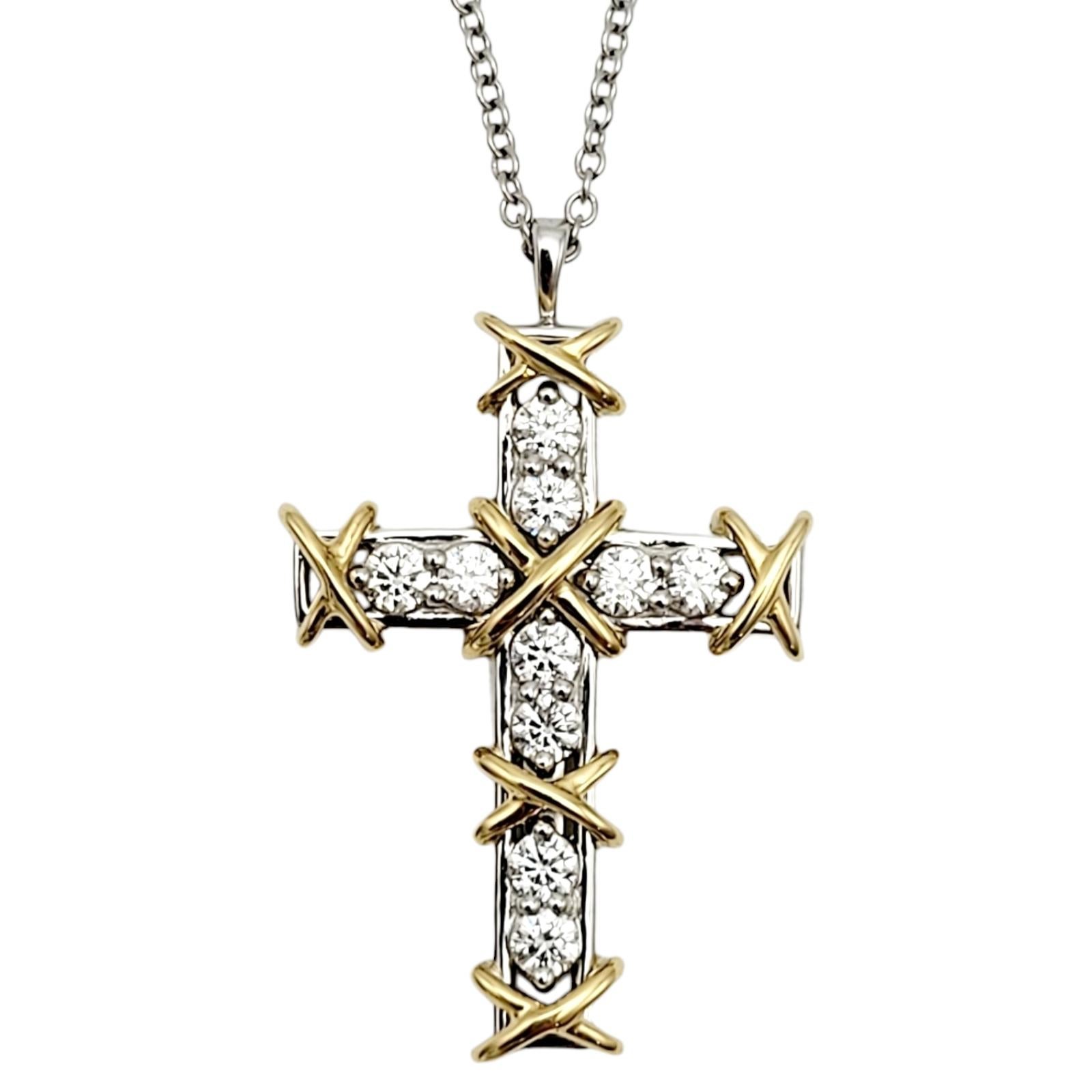 Introducing the magnificent Tiffany & Co. ten stone diamond cross pendant necklace designed by Jean Schlumberger. Founded in 1837 in New York City, Tiffany & Co. is one of the world's most storied luxury design houses recognized globally for its