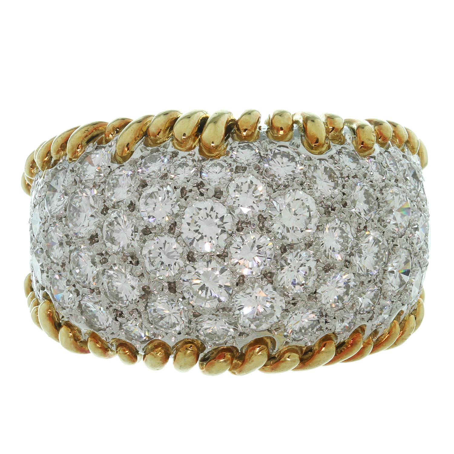 This glamorous vintage ring designed was by Schlumberger for Tiffany & Co. is crafted in 18k yellow gold and set all around with very fine quality round brilliant F-G VVS1-VVS2 diamonds weighing an estimated 4.0 - 4.25 carats. The ring size