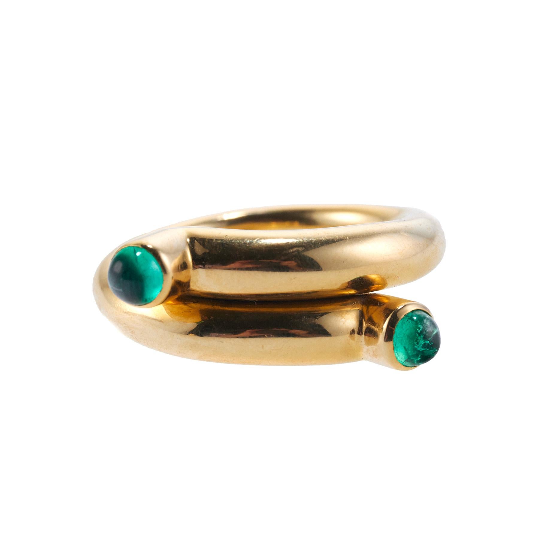 18k gold bypass ring by Jean Schlumberger for Tiffany & Co, with two emeralds. Ring size 7 and it measures 9mm wide. Marked: Tiffany & Co, Schlumberger, 750. Weight is 16 grams.