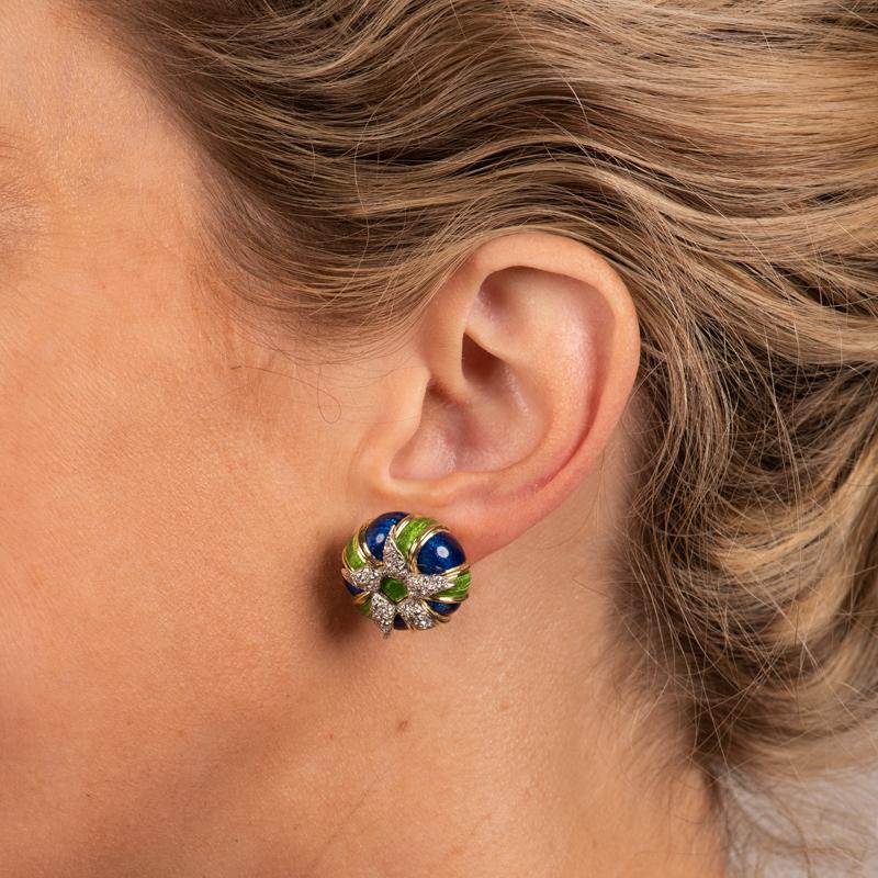 These rare and extremely unique clip on 18 karat yellow gold earrings feature royal blue and bright green enamel accented by a starfish with approximate weight of 0.60 carats of 50 round diamonds set in platinum. Omega back closure. 
Measurements: