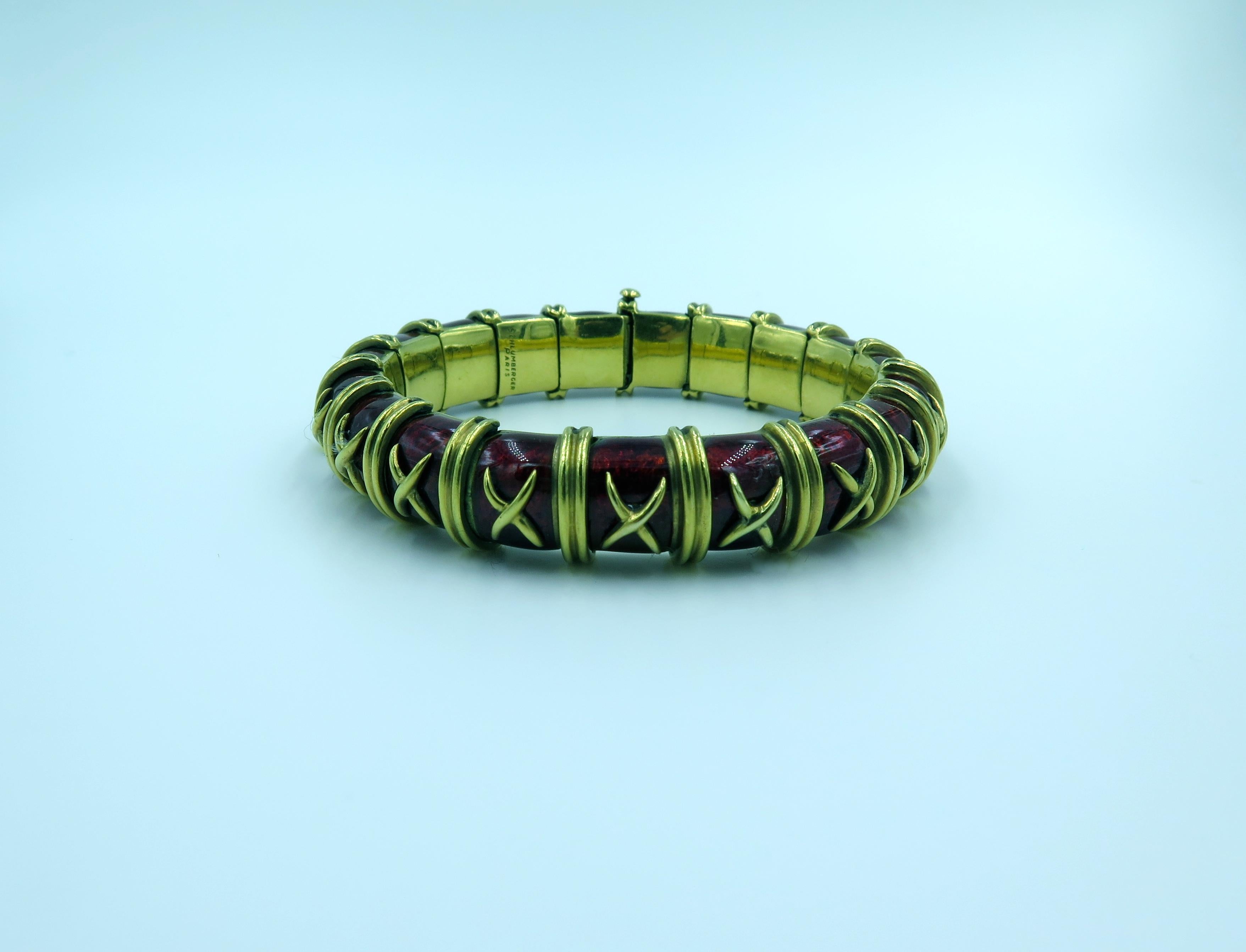 An 18 karat yellow gold and red enamel bangle bracelet.  Tiffany & Co., Schlumberger.