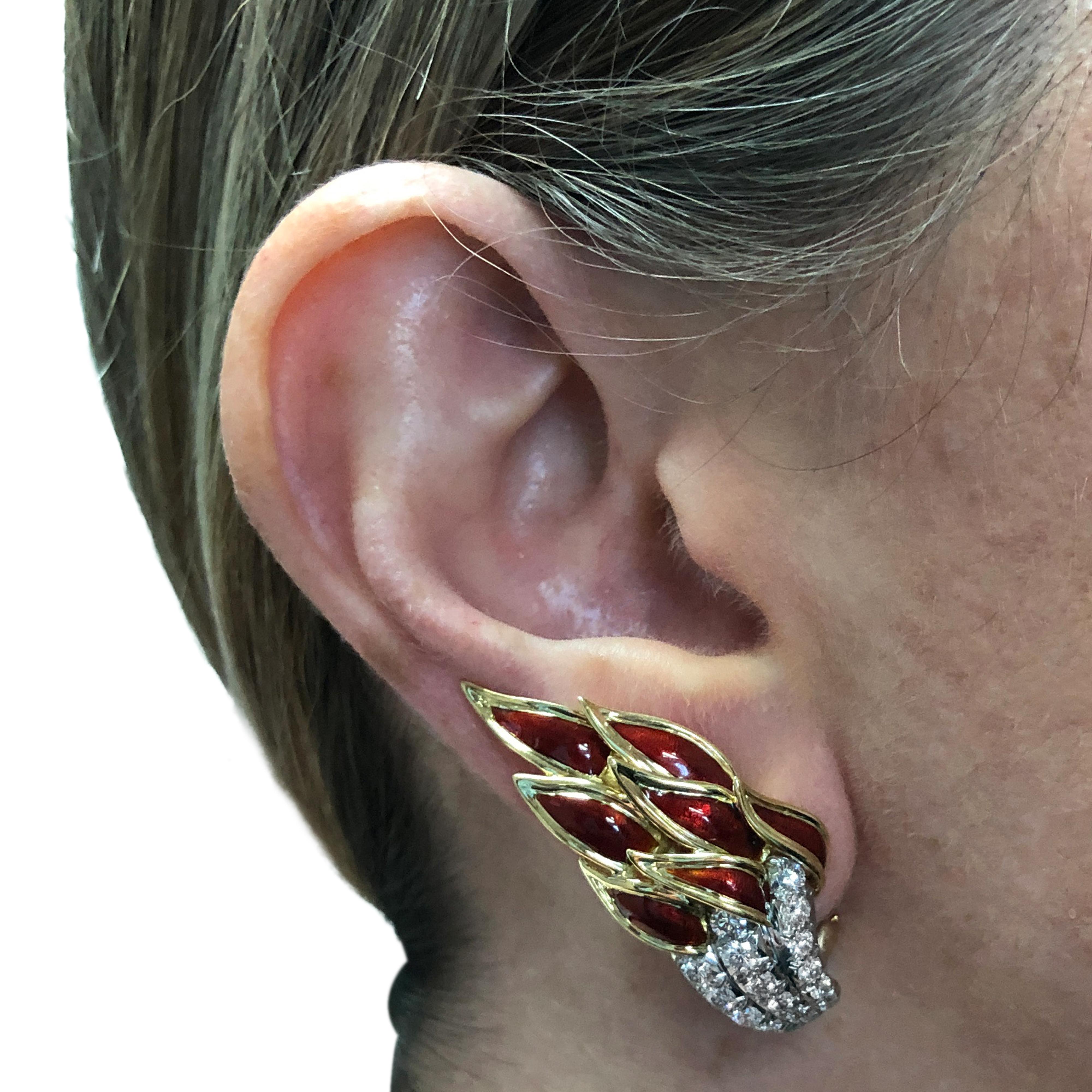 Spectacular Tiffany and Co. Schlumberger Flame earrings, crafted in 18 karat yellow gold, platinum and red enamel, featuring 34 round brilliant cut diamonds weighing approximately 2 carats total, F color, VS clarity. These stunning earrings catch