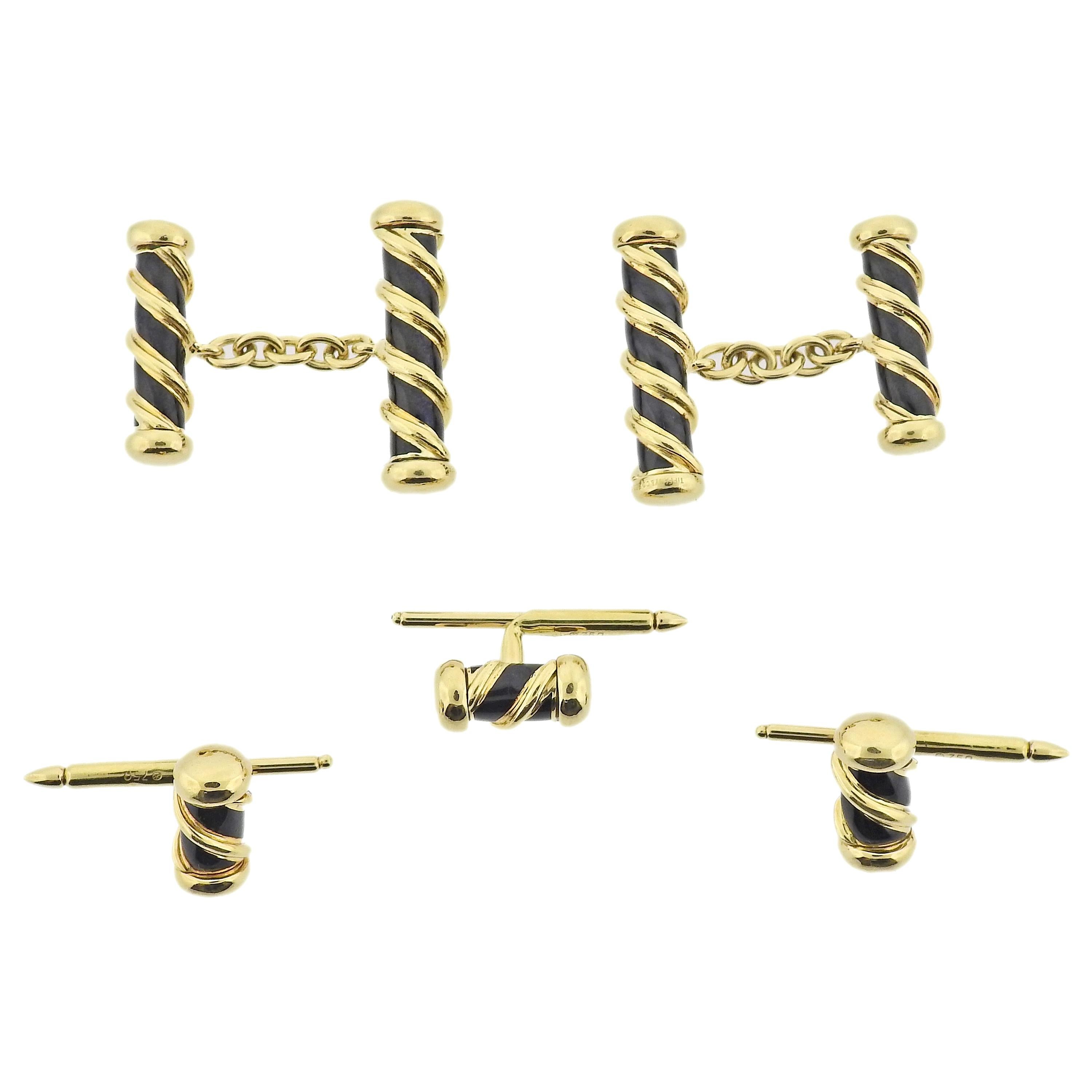 Tiffany & Co Schlumberger 18k gold scroll motif cufflinks and studs, decorated with black enamel.  Cufflink top is 25mm x 8mm, stud - 15mm x 7mm. Weight - 34.3 grams. Marked: Tiffany & Co, Schlumberger, 750. 