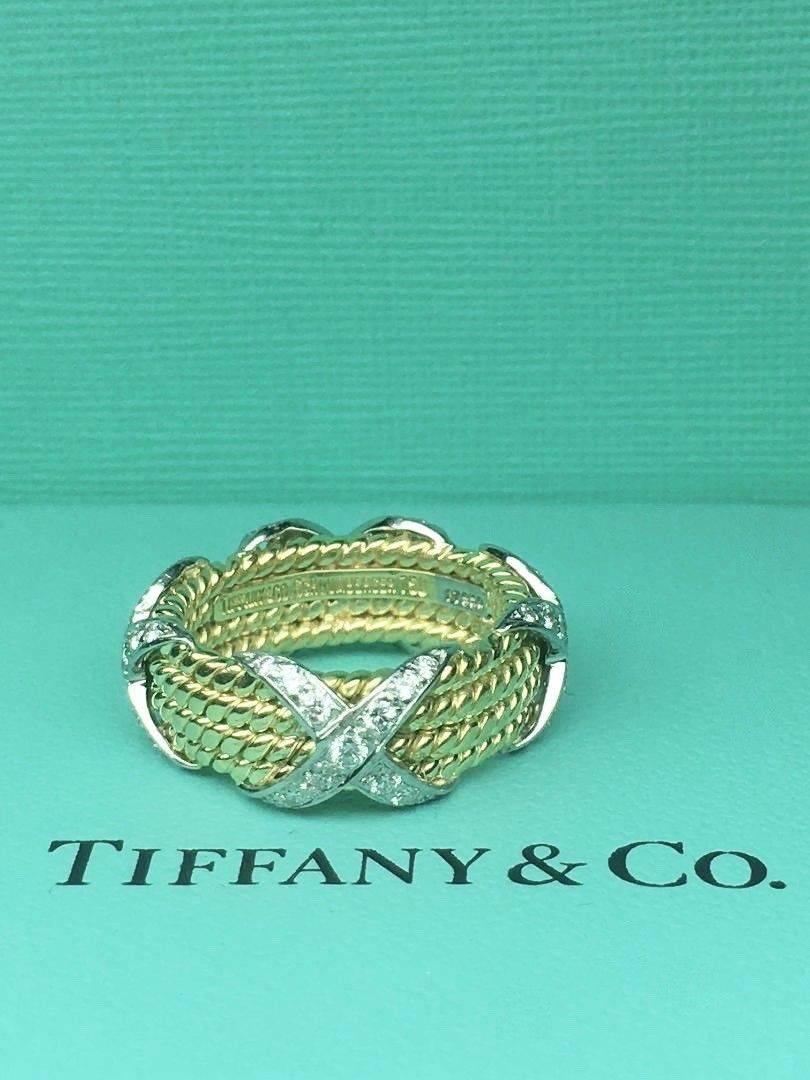 Tiffany & Co.
Style:  SCHLUMBERGER DIAMOND FOUR ROPE BAND RING
Metal:  18KT Yellow Gold & Platinum PT950
Size:  4.75
Total Carat Weight:  0.54 TCW
Diamond Shape:  Round Brilliant Diamonds 
Diamond Color & Clarity:  F / VVS
Hallmark: 