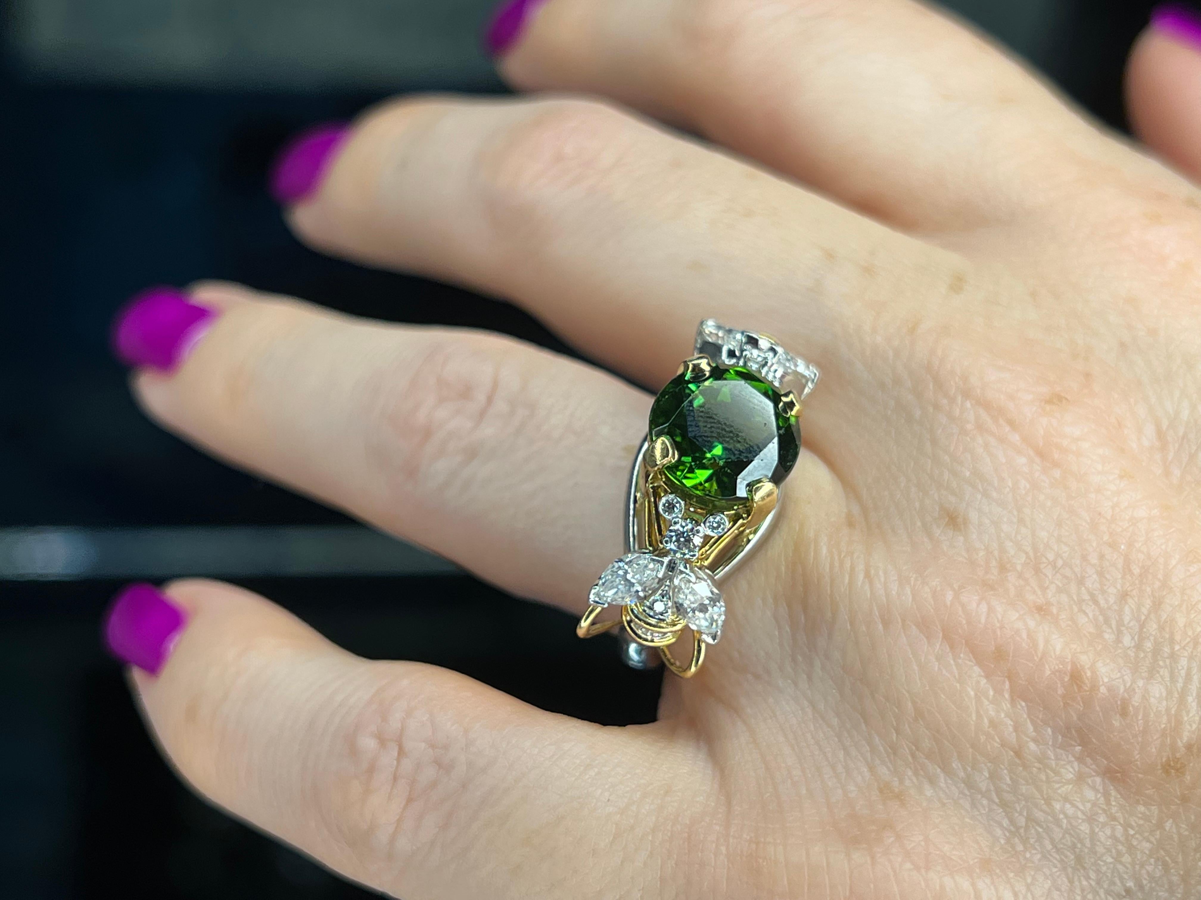 Offered here is a rare Schlumberger for Tiffany & Co iconic two bee's ring centered with a magnificent green tourmaline.
Green tourmaline measurements is 10mm by 6.55mm.
Ring is 18kt gold and platinum.
Shank was converted to a special knuckle bottom