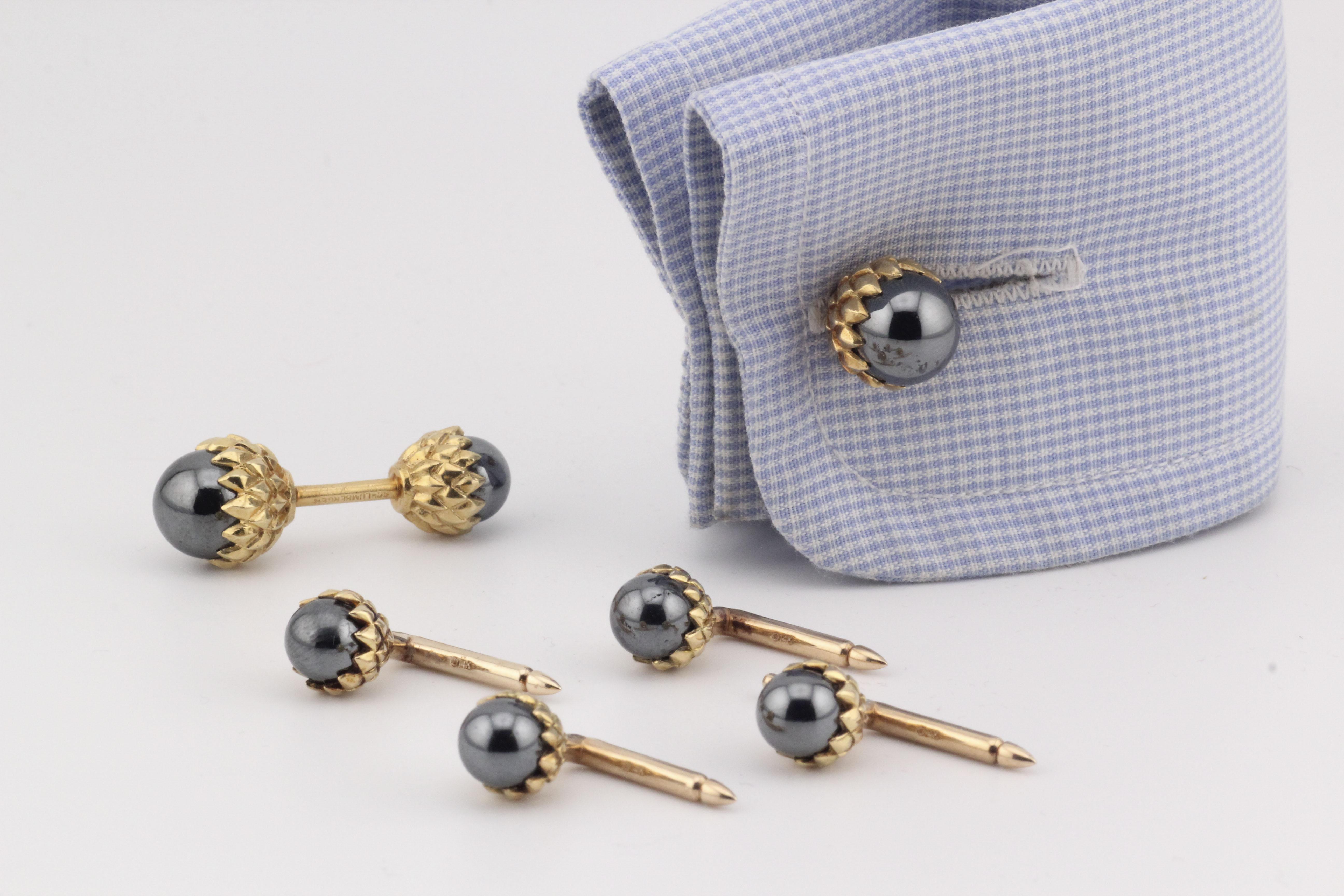 The Tiffany & Co. Schlumberger Hematite 18k Gold Acorn Cufflinks Studs Dress Set is a masterful expression of Jean Schlumberger’s iconic design vision, brought to life by Tiffany & Co. Crafted from radiant 18k yellow gold, this sophisticated dress