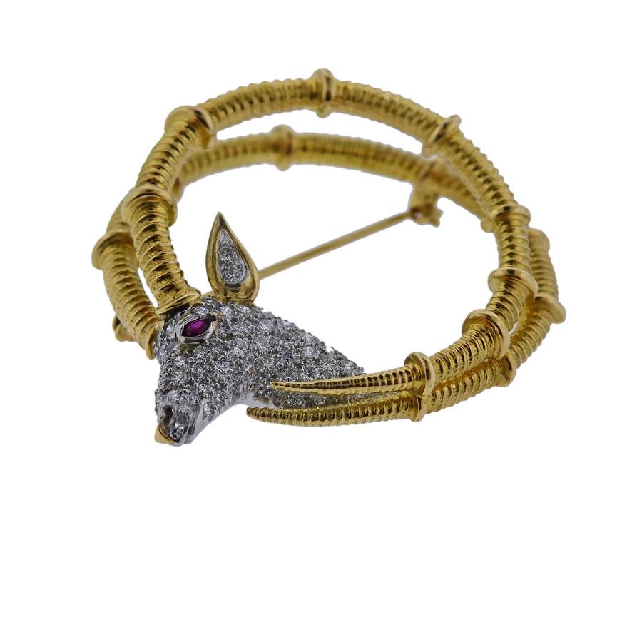Iconic 18k gold and platinum Ibex brooch, crafted by Jean Schlumberger for Tiffany & Co, adorned with a ruby eye and approx. 0.80ctw in G/VS diamonds. Brooch is 38mm in diameter and weighs 19 grams. Marked  Schlumberger 18k Tiffany & Co.