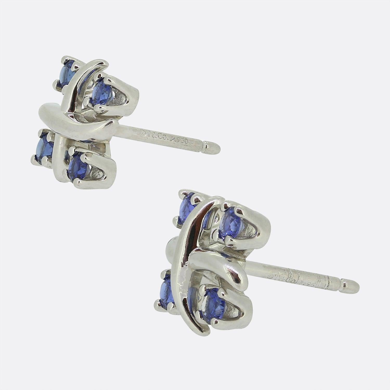 Here we have a stylish pair of sapphire earrings from the world renowned jewellery designer, Tiffany & Co. Each piece has been crafted from platinum into the iconic Schlumberger 'X' design with four round faceted, claw set sapphires for company. 