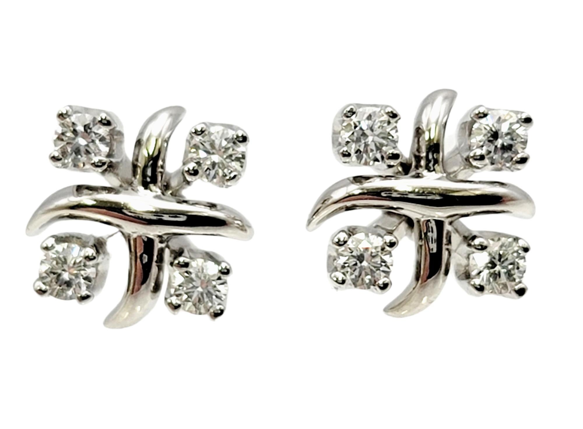 Gorgeous diamond stud earrings with a modern twist designed for Tiffany & Co. by Jean Schlumberger. These sparkling squared 'Lucy' earrings feature 4 round prong set natural diamonds with a polished platinum cross design at the center. These lovely