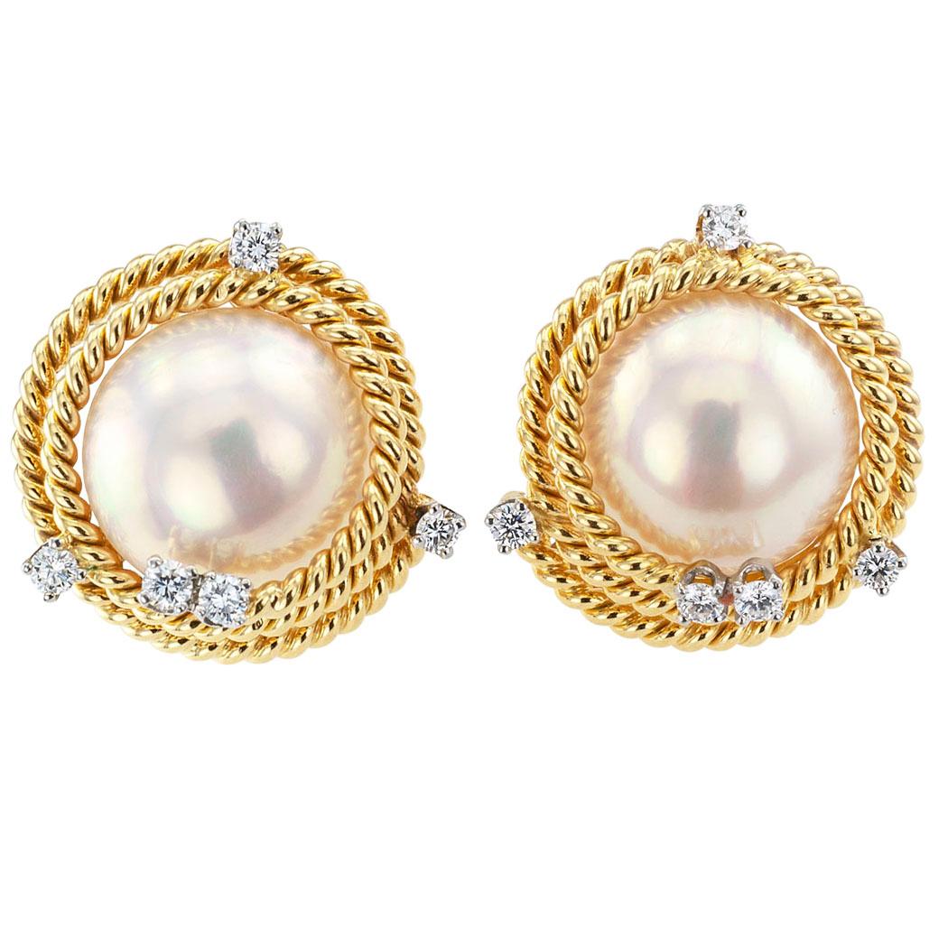Schlumberger Tiffany & Co diamond and mabe pearl gold and platinum ear clips. Featuring a pair of mabe pearls within stepped borders of corded gold studded with platinum-set round brilliant-cut diamonds totaling approximately 0.52 carat,