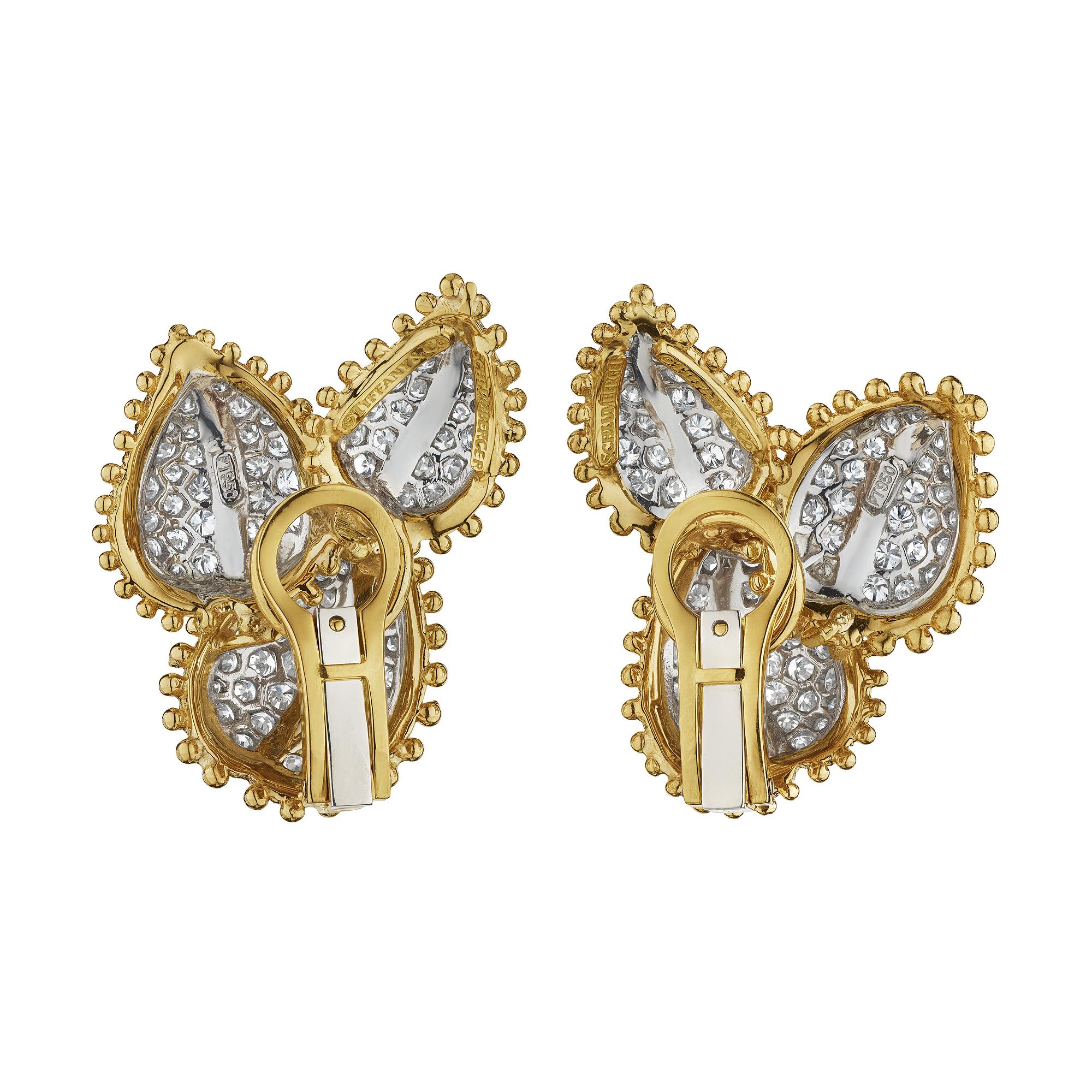 Turn over a new leaf with these Tiffany & Co. Schlumberger modernist diamond platinum and 18 karat yellow gold clip earrings.  With six undulating and overlapping diamond leaves, these luminous earrings have the fire and flair you have been looking