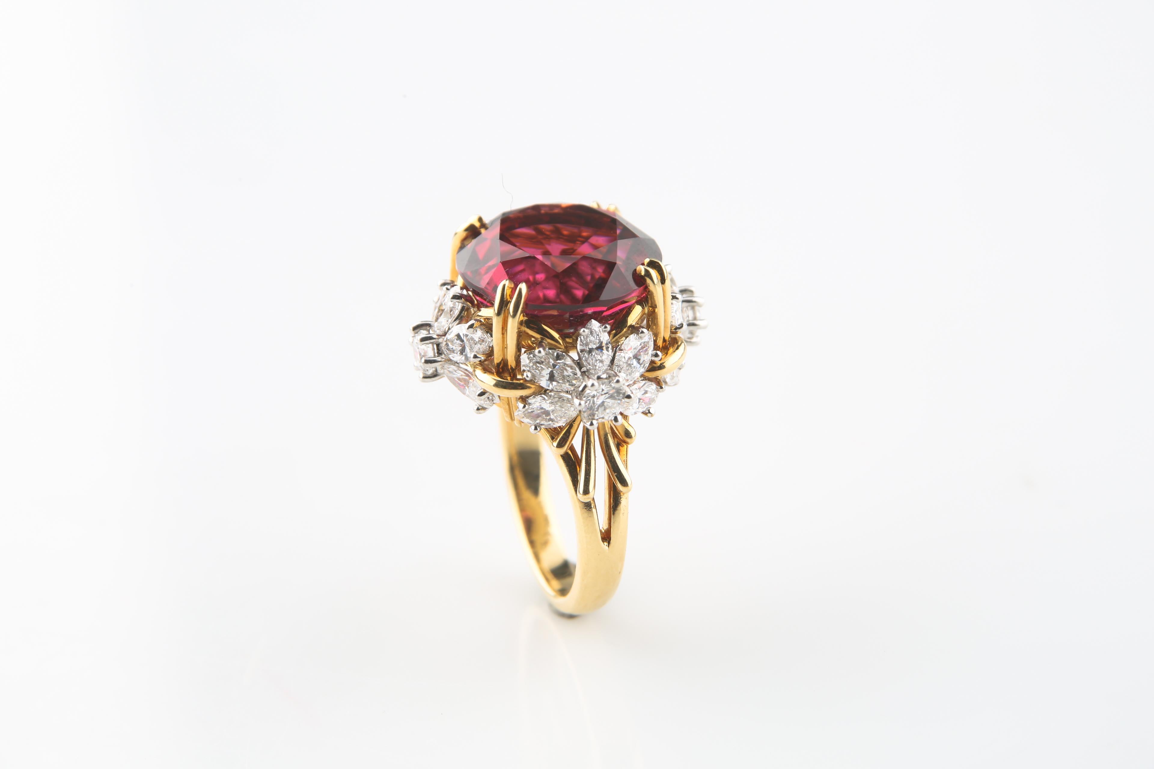 Beautiful 18k Yellow Gold & .950 Platinum Cocktail Ring
Features a Large Brilliant Round Cut Pink Tourmaline as the Center Stone
Tourmaline is Accented by Four Floral Diamond Clusters at Cardinal Directions
Each Feature Five Marquis-Cut Diamonds