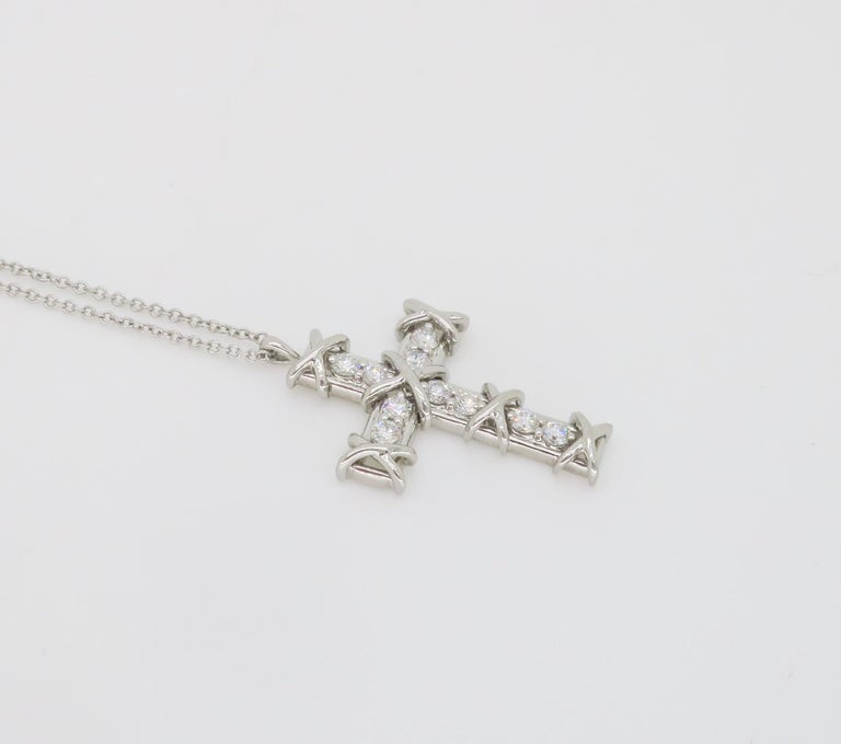 Never worn iconic Tiffany & Co. Schlumberger ten diamond cross necklace made in Platinum, that comes with original box and white ribbon, as shown in images. 

Description directly from Tiffany & Co. as follows, 

Jean Schlumberger’s visionary