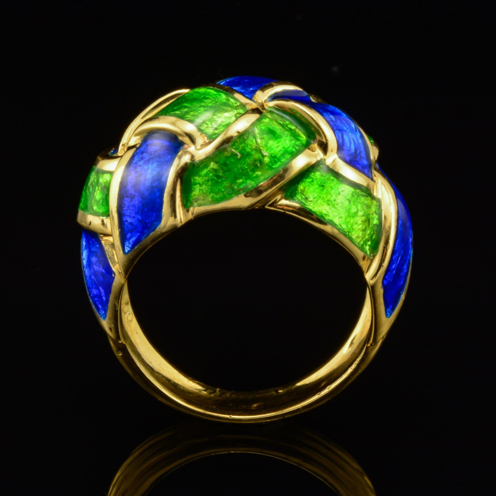 This is an authentic retro singed Tiffany & Co. French designer Schlumberger Enamel dome ring circa 1960's. The ring is expertly fashioned in solid high polish 18 karat yellow Gold bearing full hallmarks. The transparent vivid royal Blue and glowing