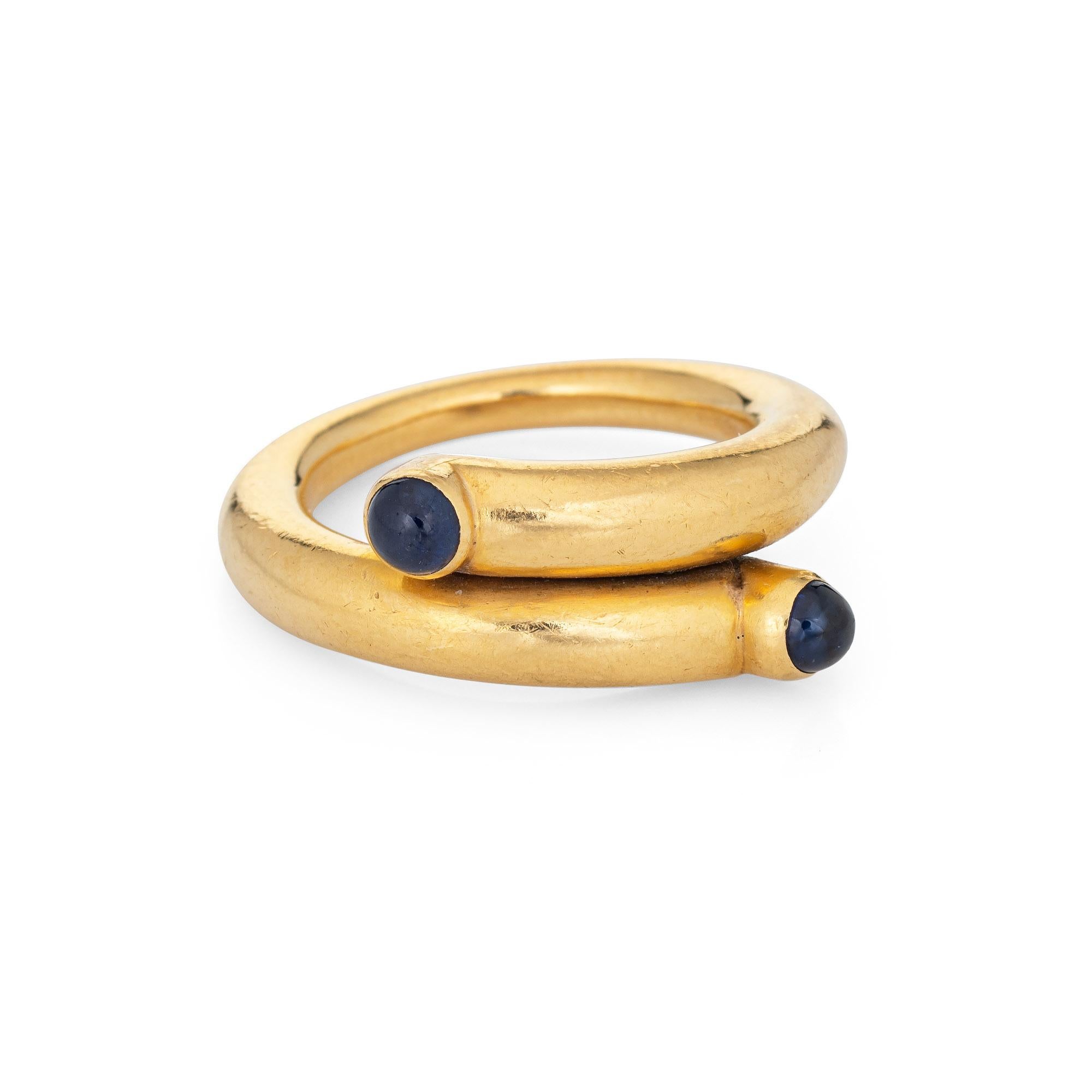 Stylish vintage Tiffany & Co Jean Schlumberger sapphire ring crafted in 18k yellow gold.   

Two 3.5mm cabochon cut sapphires are set into the band. The sapphires are in very good condition and free of cracks or chips.

The iconic 'coil' ring