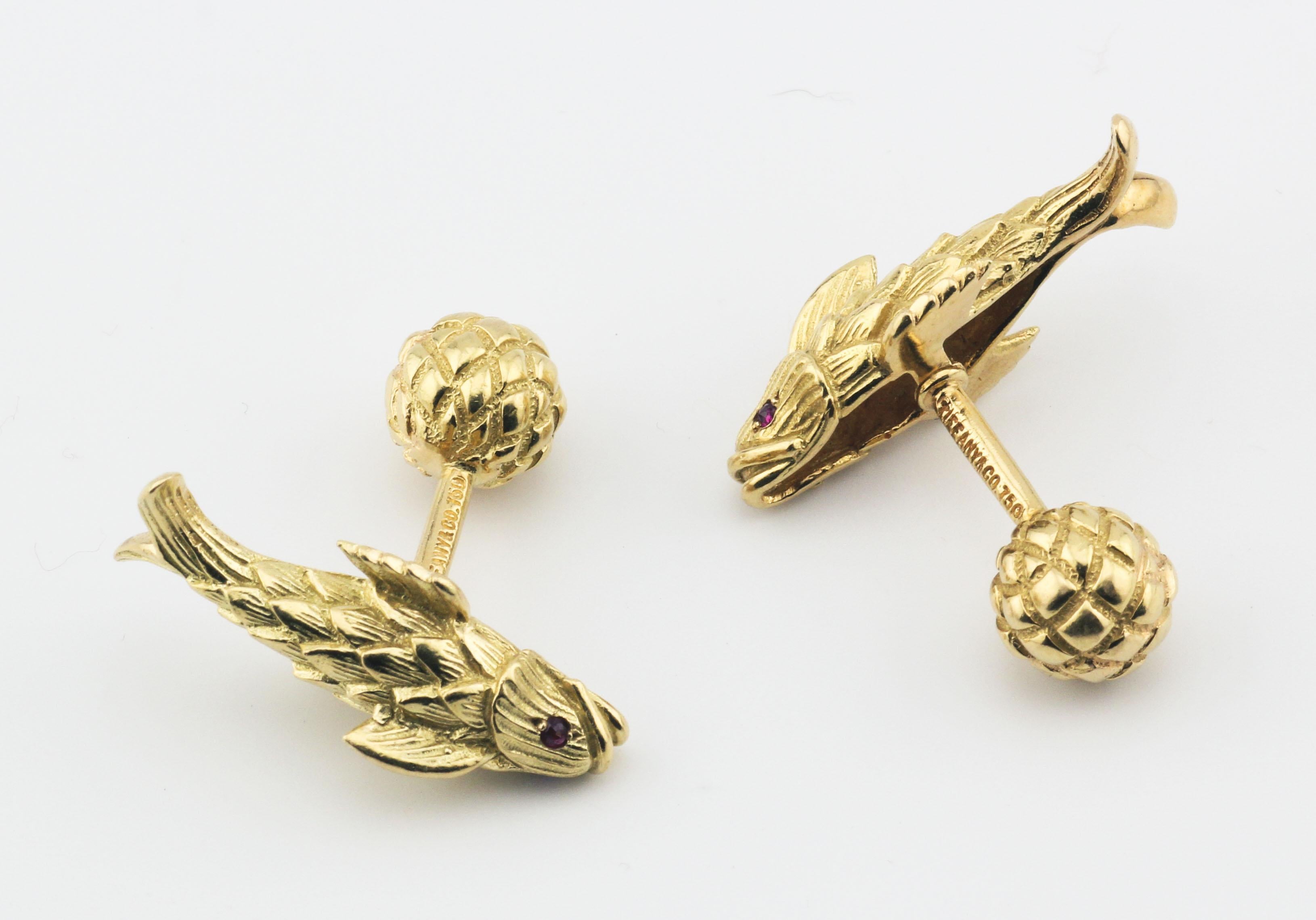 The Tiffany & Co. Schlumberger Ruby 18K Yellow Gold Koi Fish Cufflinks are a magnificent example of the artistry and creativity of Jean Schlumberger, one of Tiffany & Co.'s most celebrated designers. These cufflinks are crafted in rich 18K yellow