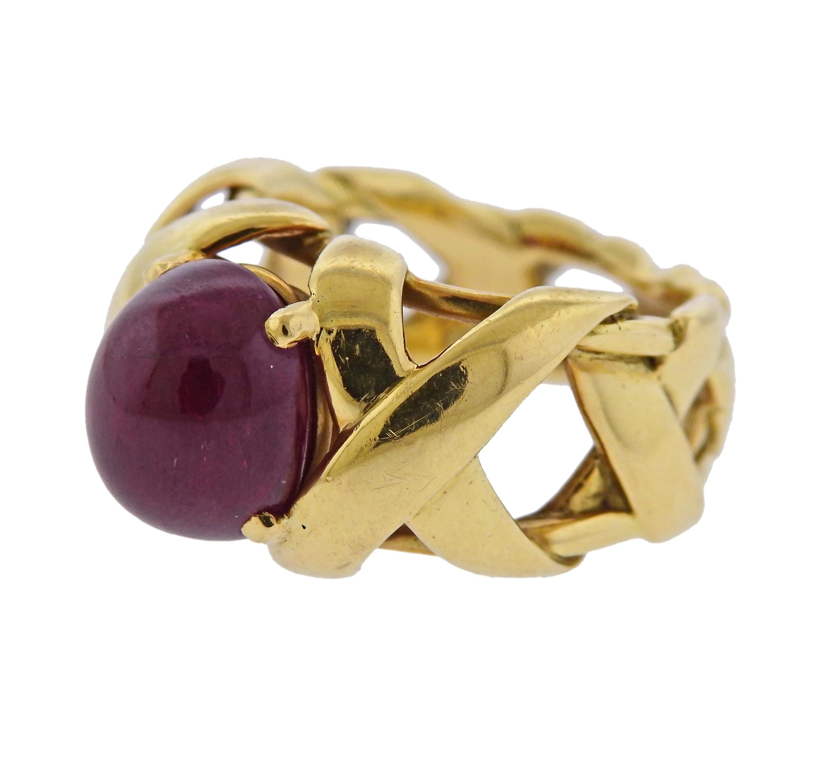 18k yellow gold X design ring, crafted by Jean Schlumberger for Tiffany & Co, set with oval ruby cabochon, measuring 10.5mm x 8.65mm x 7.03mm , weighing approximately 6.90ct. Ring size 5, ring is 13mm wide. Marked Tiffany, Schlumberger, 18k.