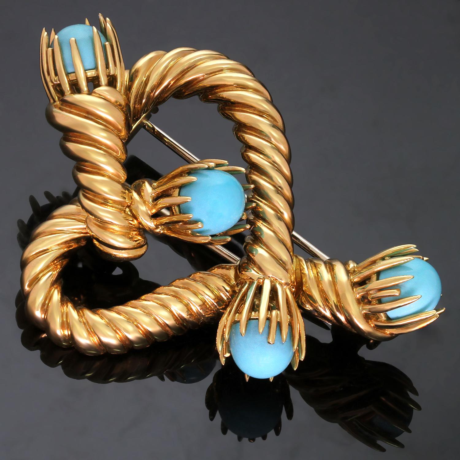 This classic Tiffany & Co. brooch features a gorgeous heart-shaped design by Schlumberger crafted in 18k yellow gold and set with 4 turquoise stones. Made in United States circa 2000s. Measurements: 1.49