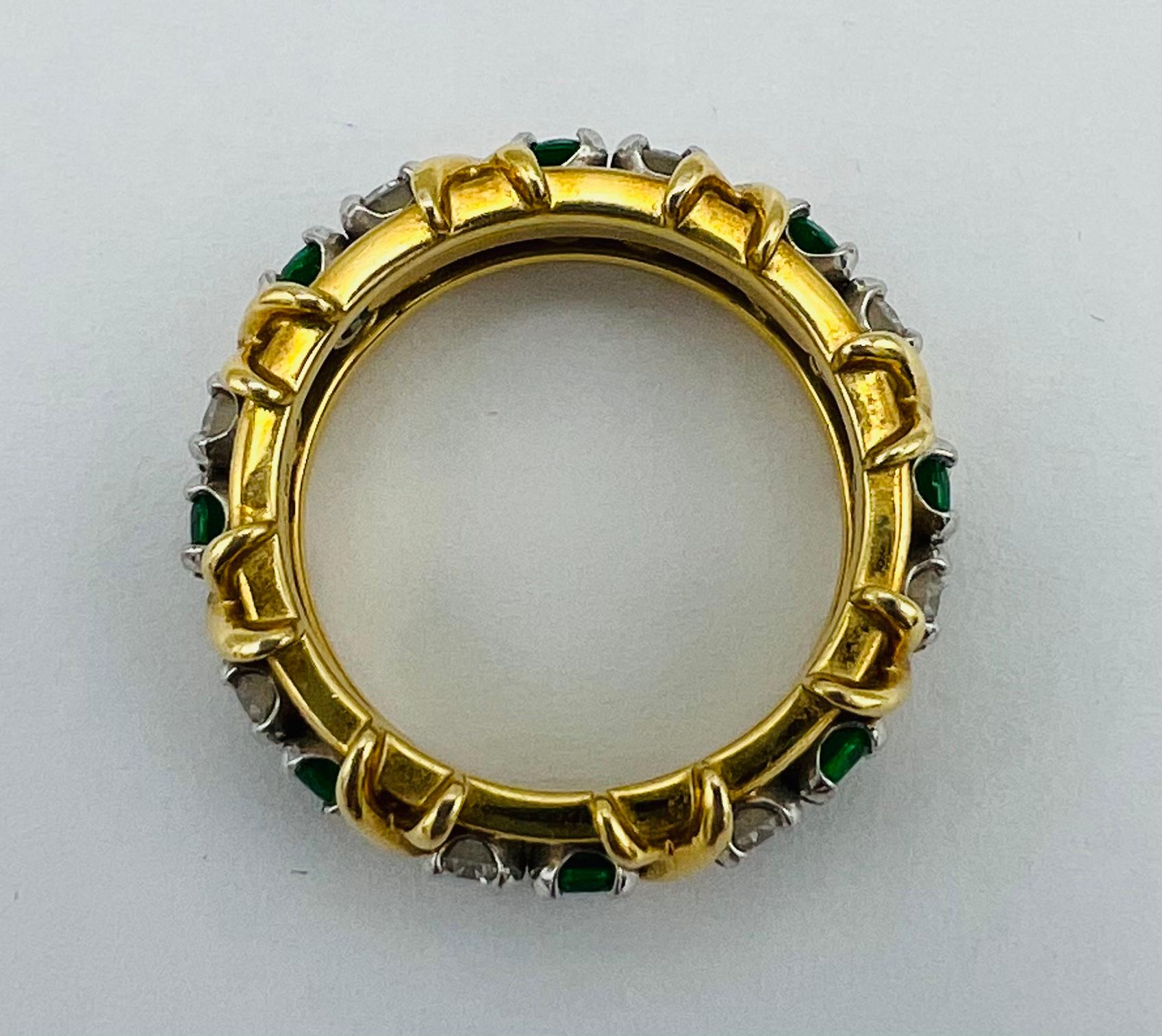 Product details:

The ring made out of 18k yellow gold and platinum with 16 stones around it, including 0.65 carat of round brilliant cut diamond and 0.65 carat of emerald. The ring features x motif around the band. The ring comes with the original