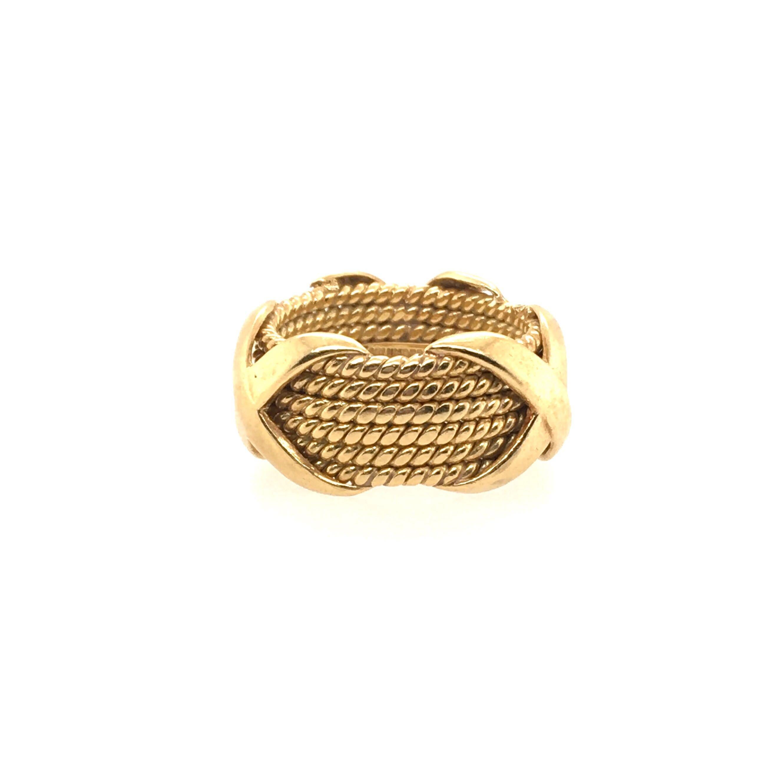 An 18 karat yellow gold Rope Six-row X Ring. Schlumberger, Tiffany & Co,. Size 5, gross weight 10.8 grams. 