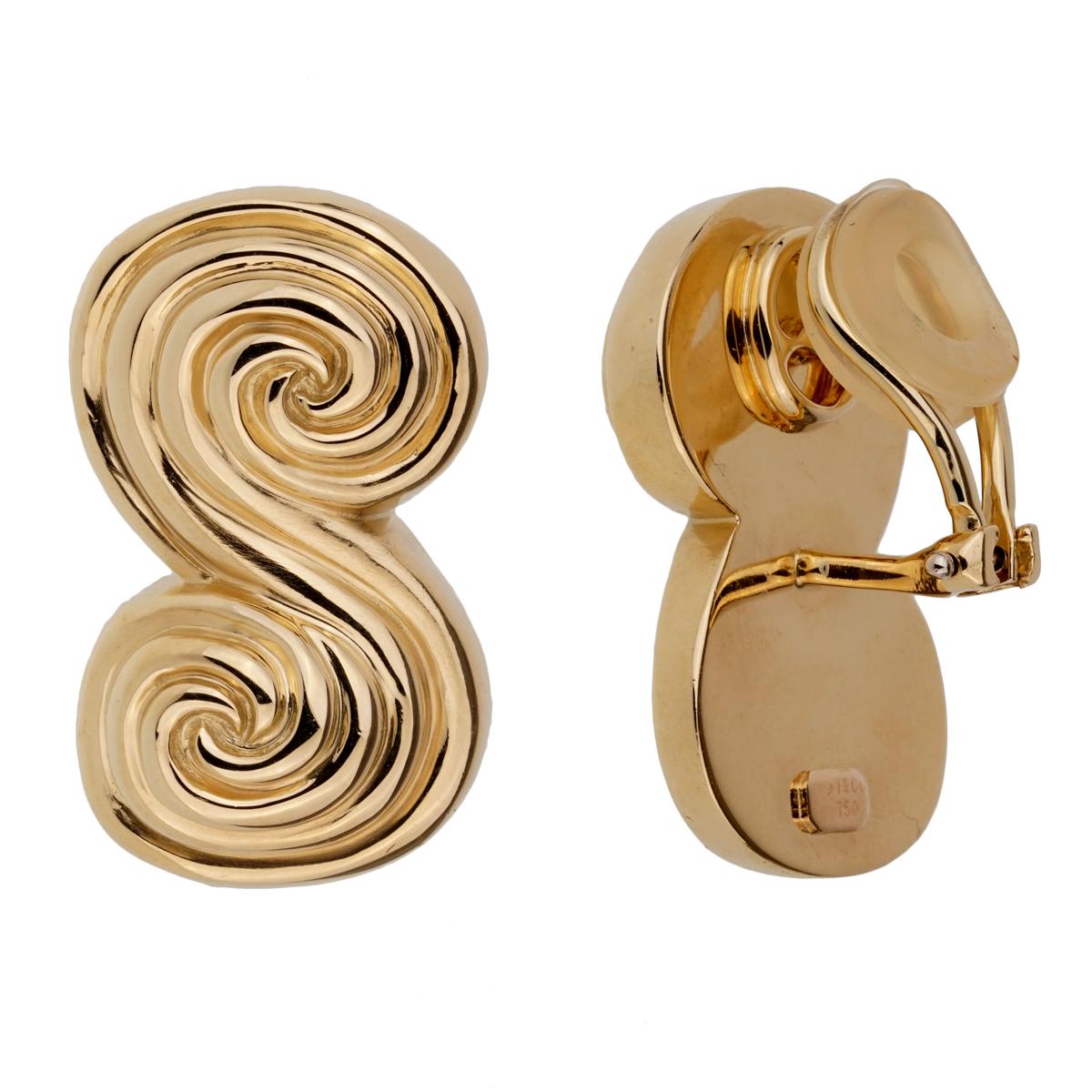 A chic pair of Tiffany & Co earrings featuring a scroll motif in 18k yellow gold. The earrings are circa 1995. The earrings measures .59