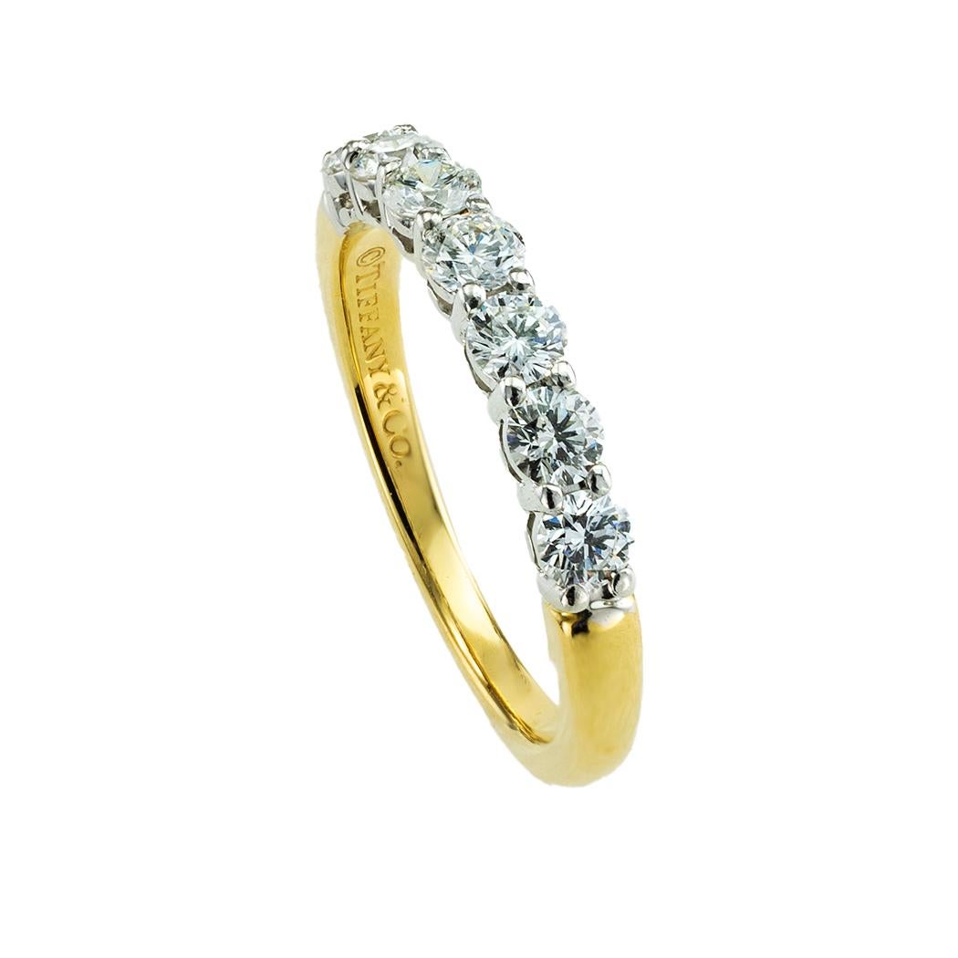 Tiffany & Co seven-stone diamond platinum and yellow gold wedding band.*

ABOUT THIS ITEM:  # R-DJ1030D. Tiffany & Co’s seven-stone diamond ring (the Tiffany Forever half-round ring) can be worn by itself or with your engagement ring or stacking