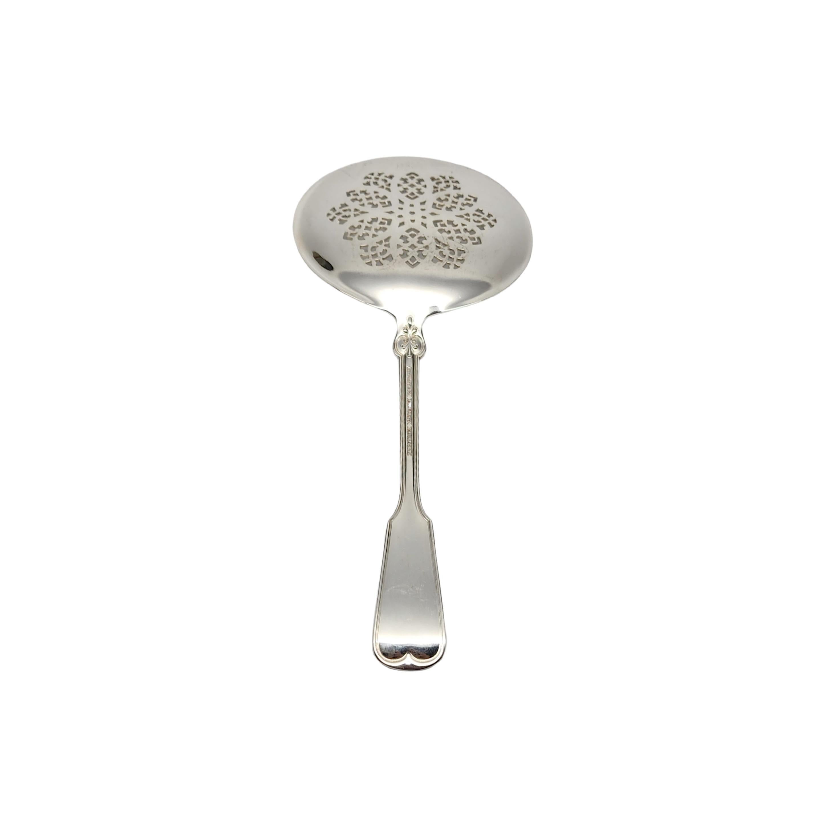 Sterling silver tomato server in the Shell & Thread pattern by Tiffany & Co with monogram.

Monogram appears to be C

The Shell & Thread pattern was introduced in 1905, and continues to be one of the most in-demand of Tiffany's classic patterns. The
