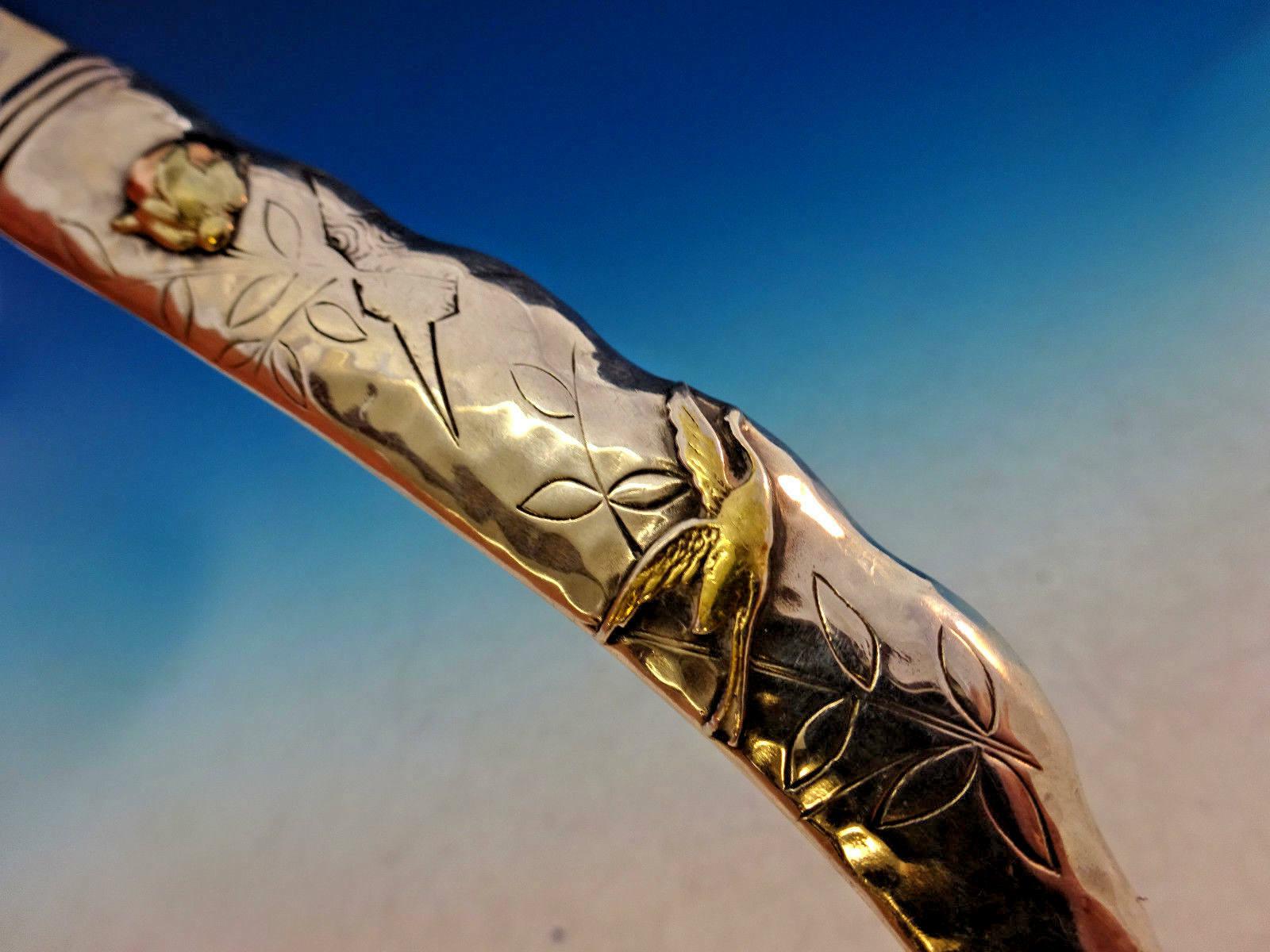 Shiebler

Wonderful George Shiebler sterling silver hollow handle all-sterling paper knife with applied mixed metal elements including a gold bird in flight and two copper/gold fruit, also with chased leaves and geometric design, circa 1880,