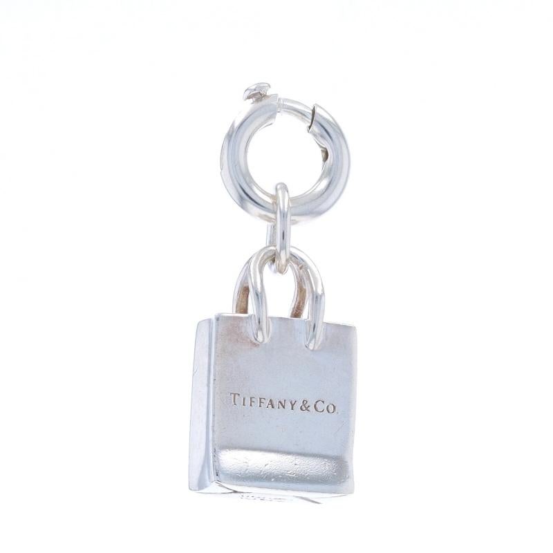Brand: Tiffany & Co.

Metal Content: Sterling Silver

Fastening Type: Spring Ring Clasp
Theme: Shopping Bag, Retail Therapy

Measurements

Wide: 15/32