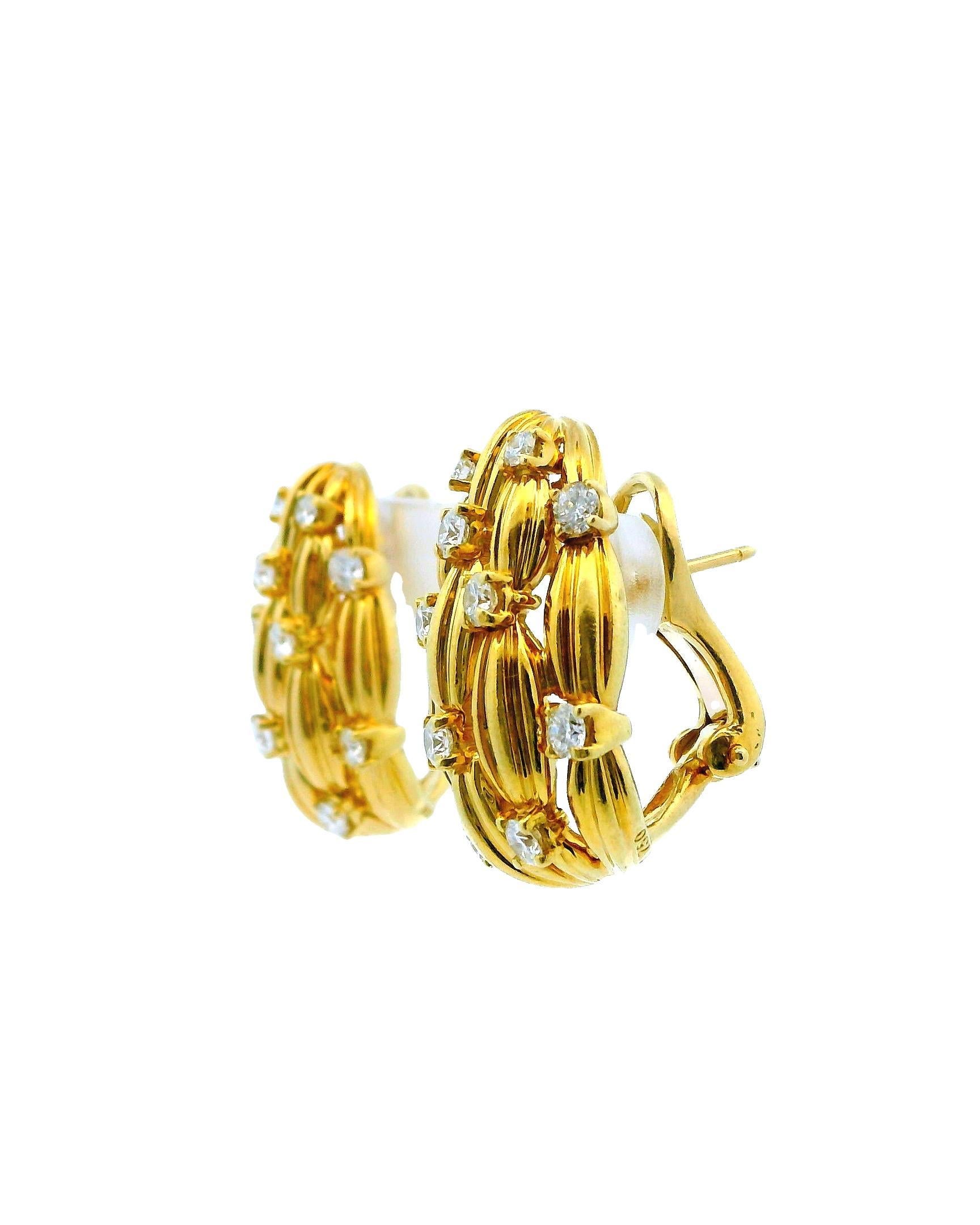 These exquisite ear clips are a stunning example of vintage jewelry, crafted from 18K yellow gold and adorned with brilliant diamonds. Created by Tiffany & Co. in 1992, they belong to the prestigious 