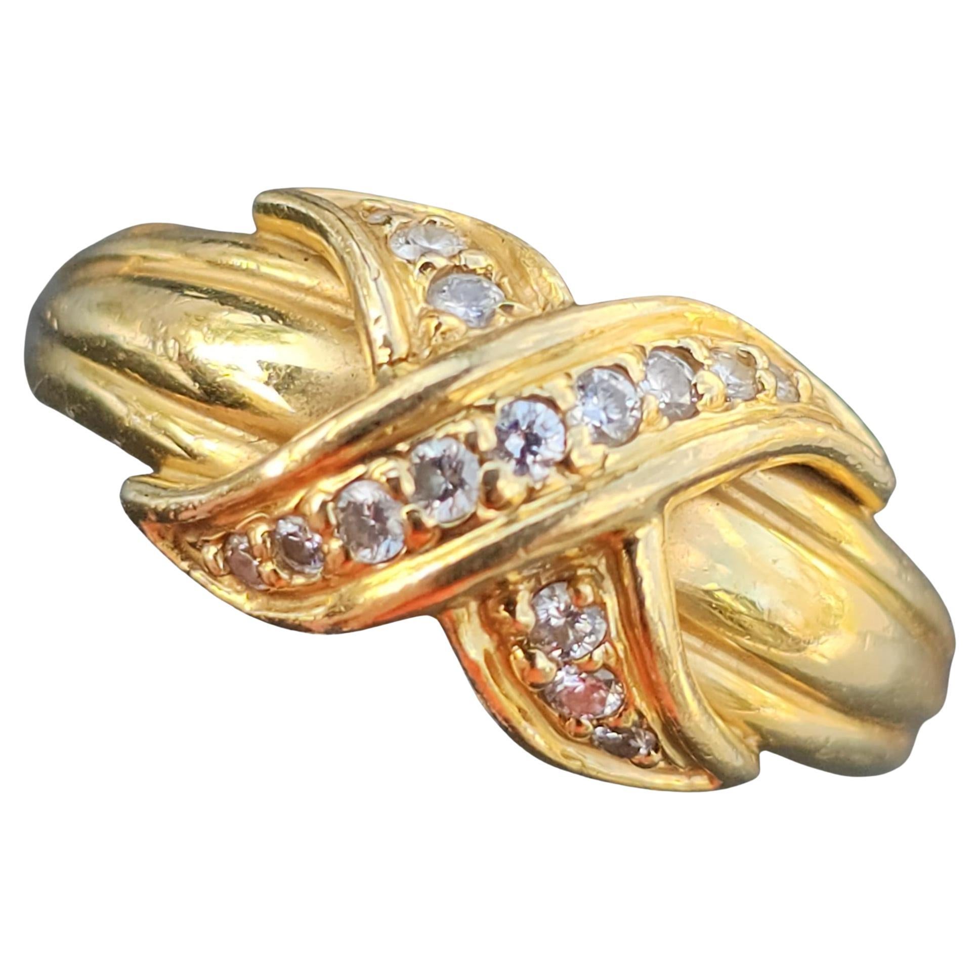 This Tiffany & Co. Signature X diamond Band Ring is a captivating piece of fine jewelry that exudes sophistication. Crafted from 18k yellow gold, this ring is both luxurious and enduring. The design features a series of white diamonds, adding a