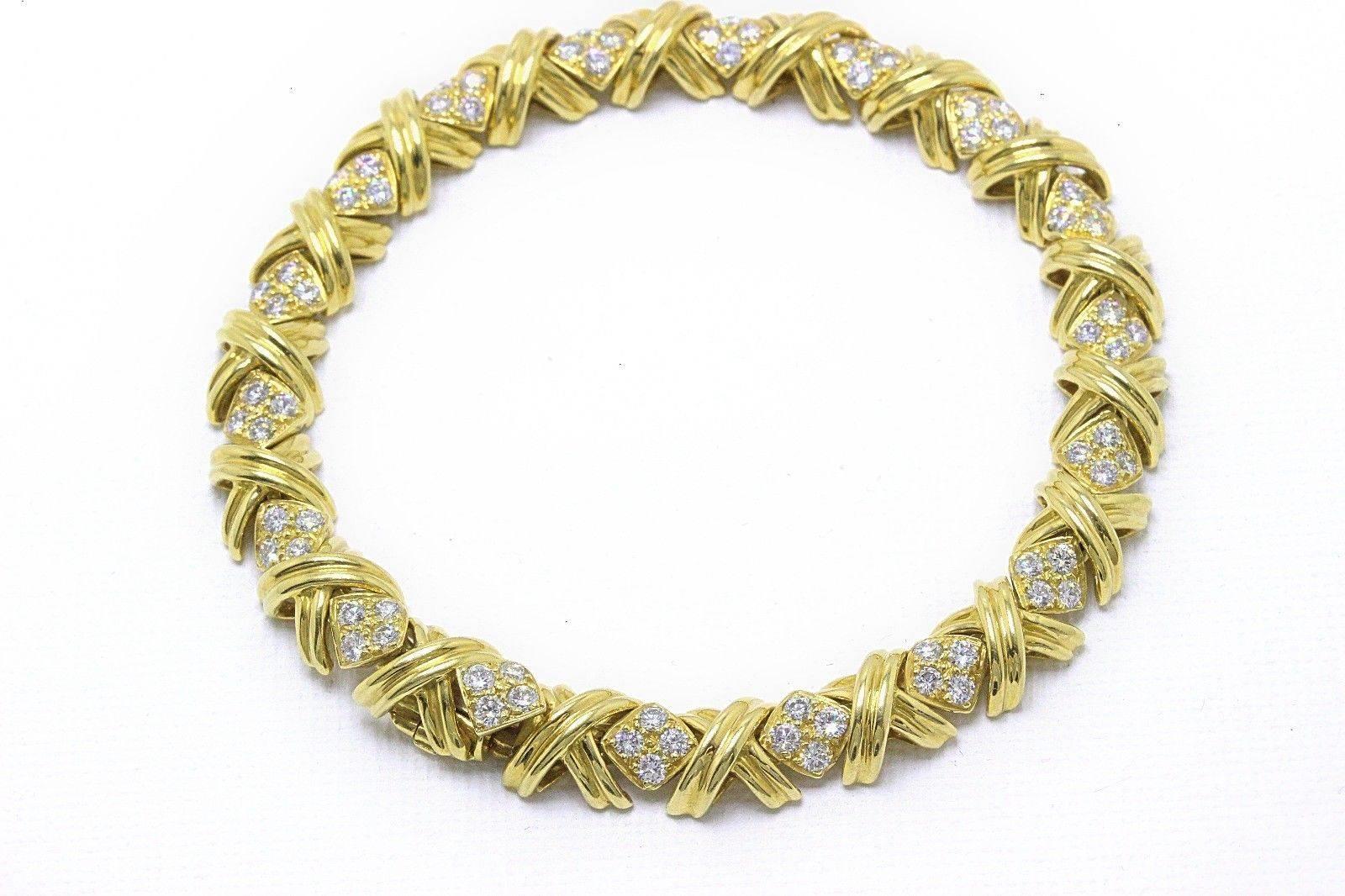 TIFFANY & COMPANY

Style:  Signature X Diamond Bracelet
Metal:  18K Yellow Gold - 750
Length:  7 Inches
Total Carat Weight:  2.00TCW
Diamond Shape:  Round Full Cut Diamonds ( 72 Stones )
Diamond Color & Clarity:  F / VVS
Hallmark:  ©T&CO. 750 on