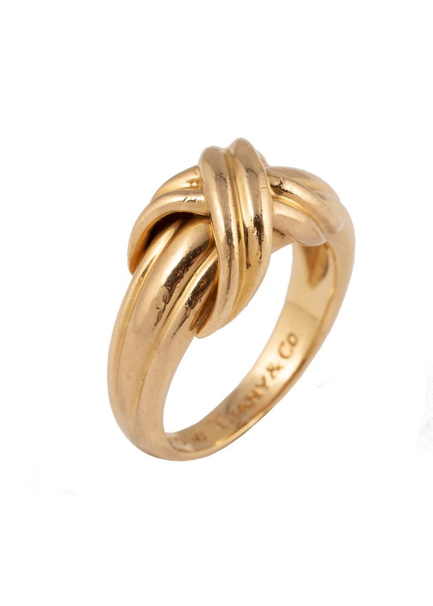 An elegant Tiffany & Co. 18k gold ring designed as a raised X motif on a tapered band.

Signed Tiffany & Co, 750 c 1990

Ring Size 4

8.5 mm widest; 2.7 mm most narrow (shank); 5.3 mm high
