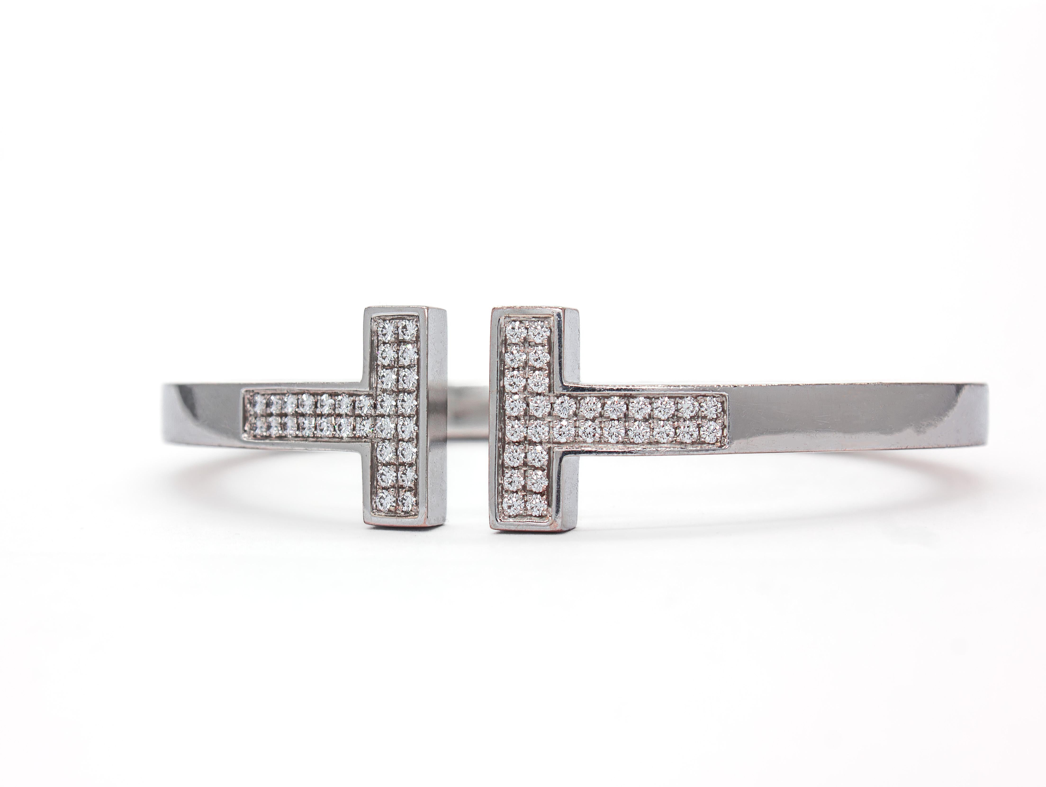 Veredeln Sie Ihr Handgelenk mit zeitlosem Luxus von Tiffany & Co. Dieses authentische quadratische Armband aus 18 Karat Weißgold mit Diamantenpavé ist ein atemberaubendes Statement für Handwerkskunst und kultiges Design. Das Armband ist mit 0,74