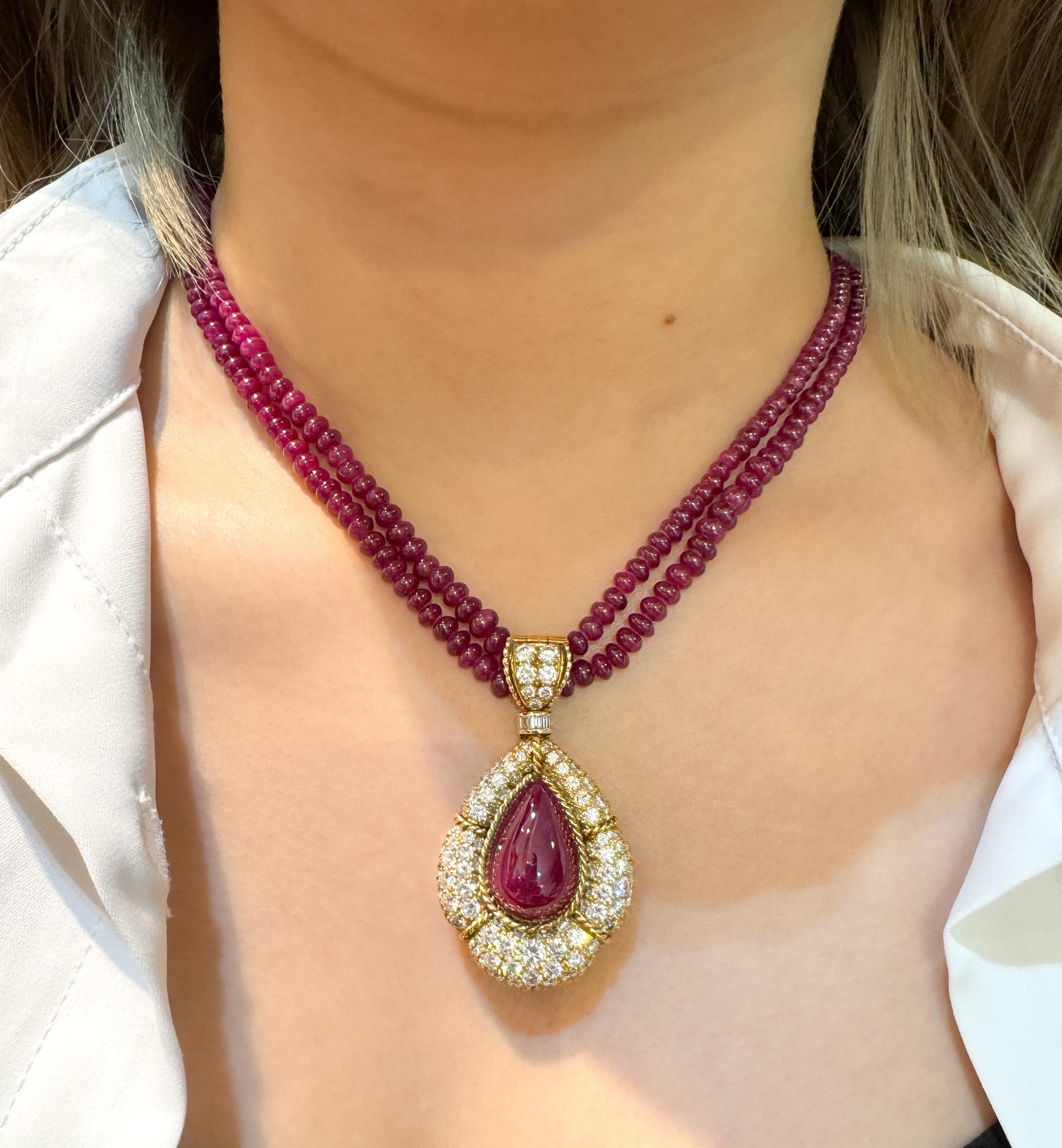 Vintage 22.41 Carat No Heat Pear Cabochon Cut Ruby and Diamond Pendant with a 2-Strand Ruby Bead Necklace by Tiffany & Co. 

Pendant Details: 
- Metal: 18K Gold
- Gross Weight: 27.57 Grams
- Gemstone: Ruby 
- Carat: 22.41 CTTW
- Color: Red 
- Cut: