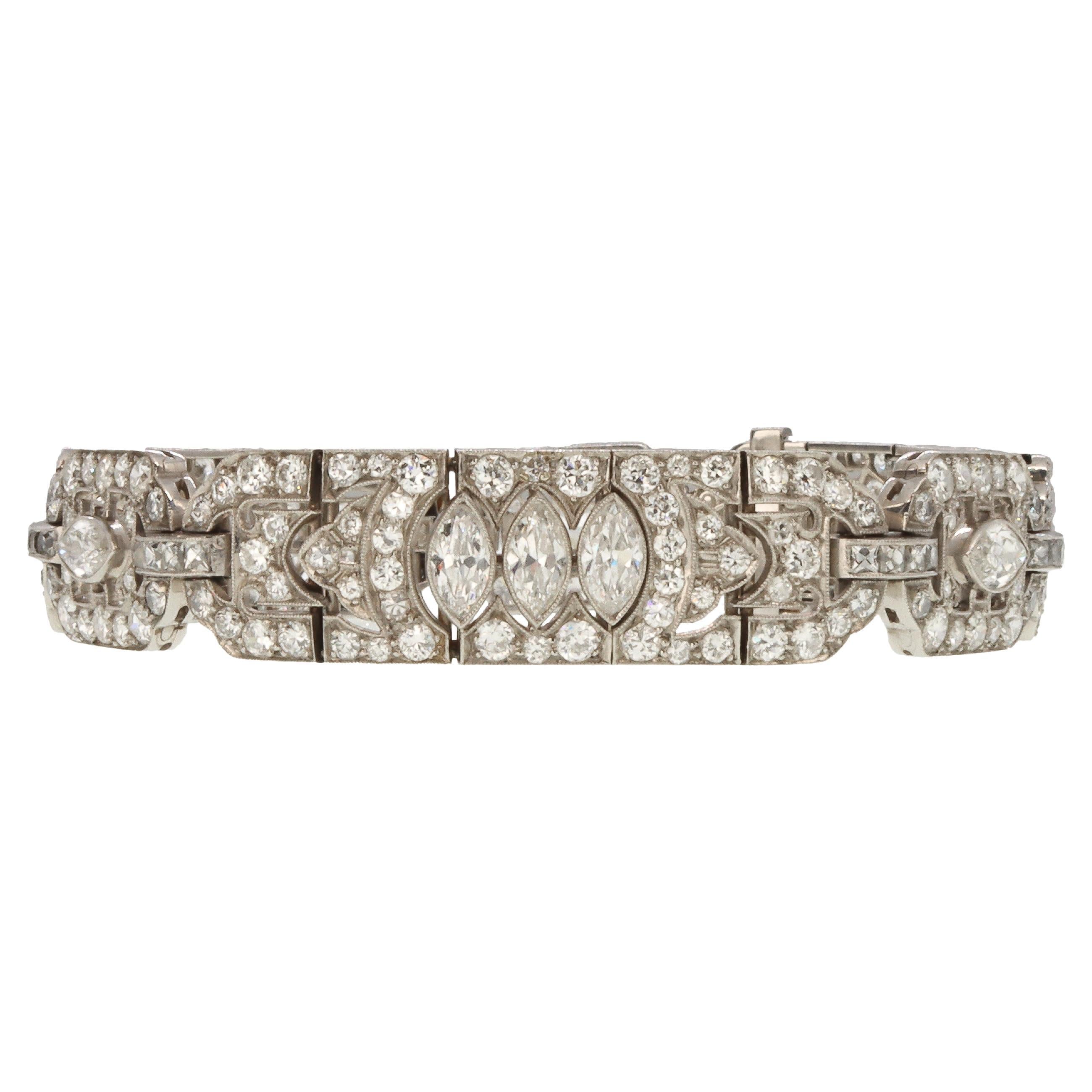 This exceptional Tiffany & Co. Diamond and Platinum Art Deco Bracelet consists of six sections set with two hundred and fifty two diamonds totalling an estimated 9.05 carats. The diamonds consist of twelve Marquise cut, two hundred and sixteen Round
