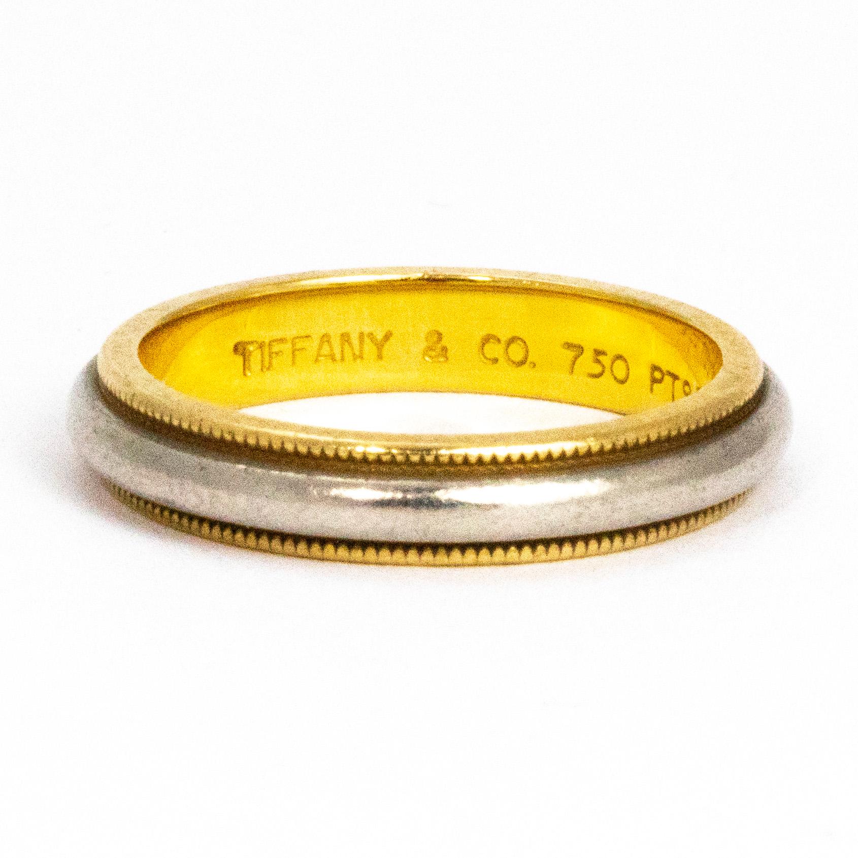 This gorgeous Tiffany & Co band is modelled out of 18ct gold and platinum. The smooth platinum band sits on top of the 18ct gold band with milgrain detail. The mix of the two tone metals give a very stylish feel to the ring. On the inner side of the