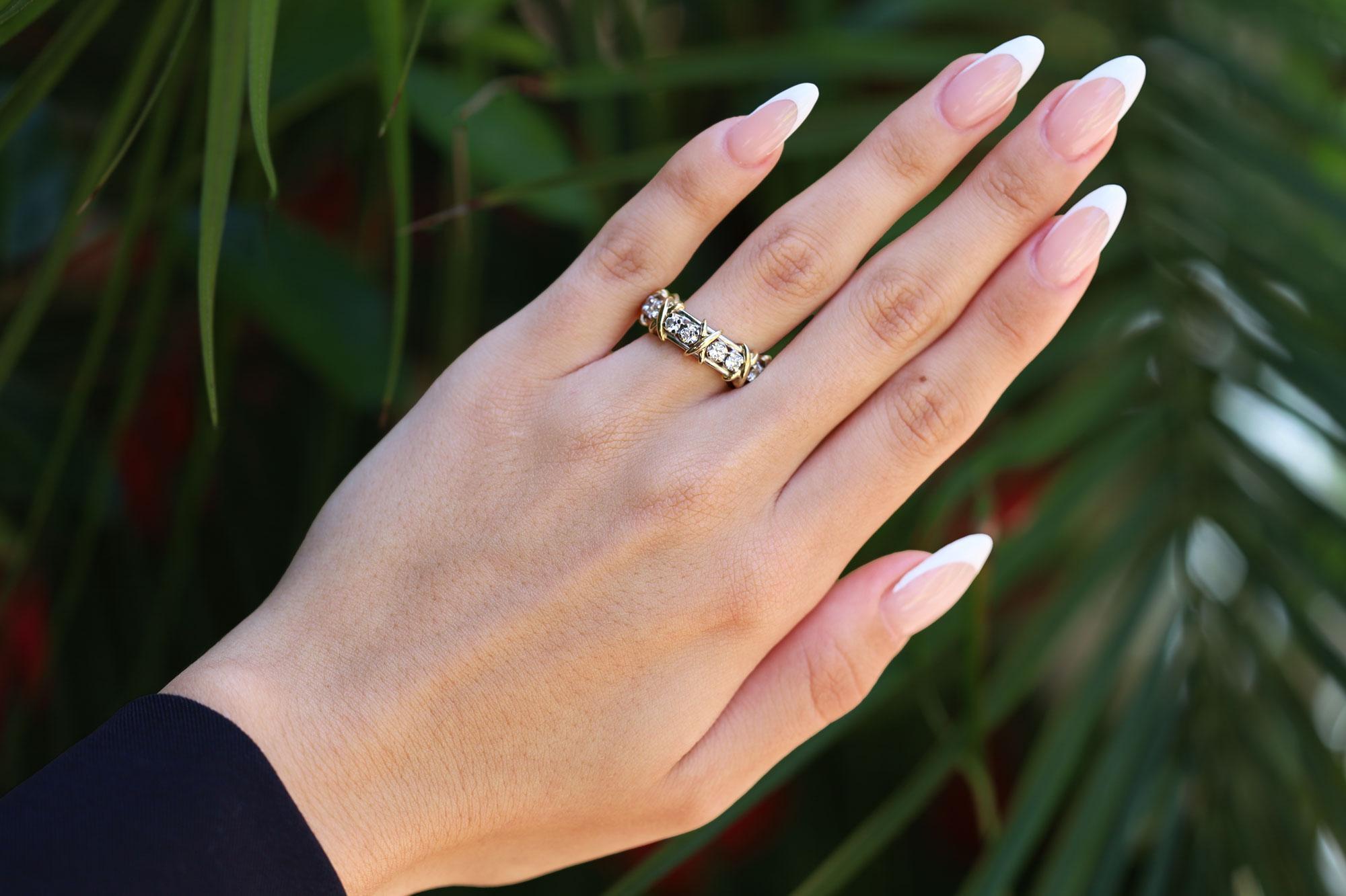 Luxuriate in Jean Schlumberger’s visionary creation. This iconic Tiffany & Co. diamond eternity wedding band is famed as one of the world’s most intricate designs. Brilliant diamonds alternate with golden X's to create this dazzling design. A