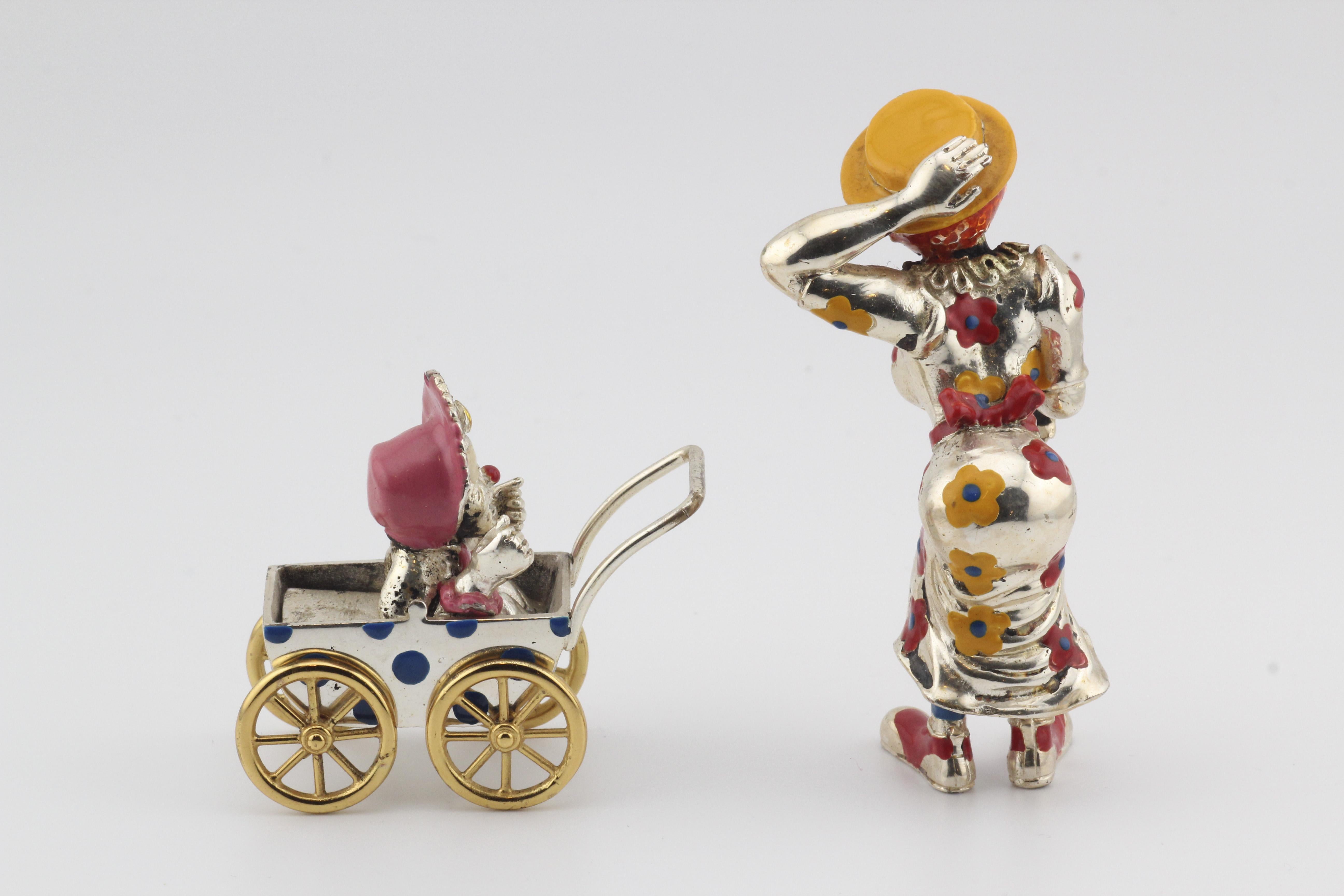 Step into the enchanting world of whimsy and craftsmanship with this Tiffany & Co. Silver & Enamel Circus Clown Mother & Baby in Carriage Figurine. Meticulously crafted, this figurine is a testament to Tiffany & Co.'s legacy of creating exceptional