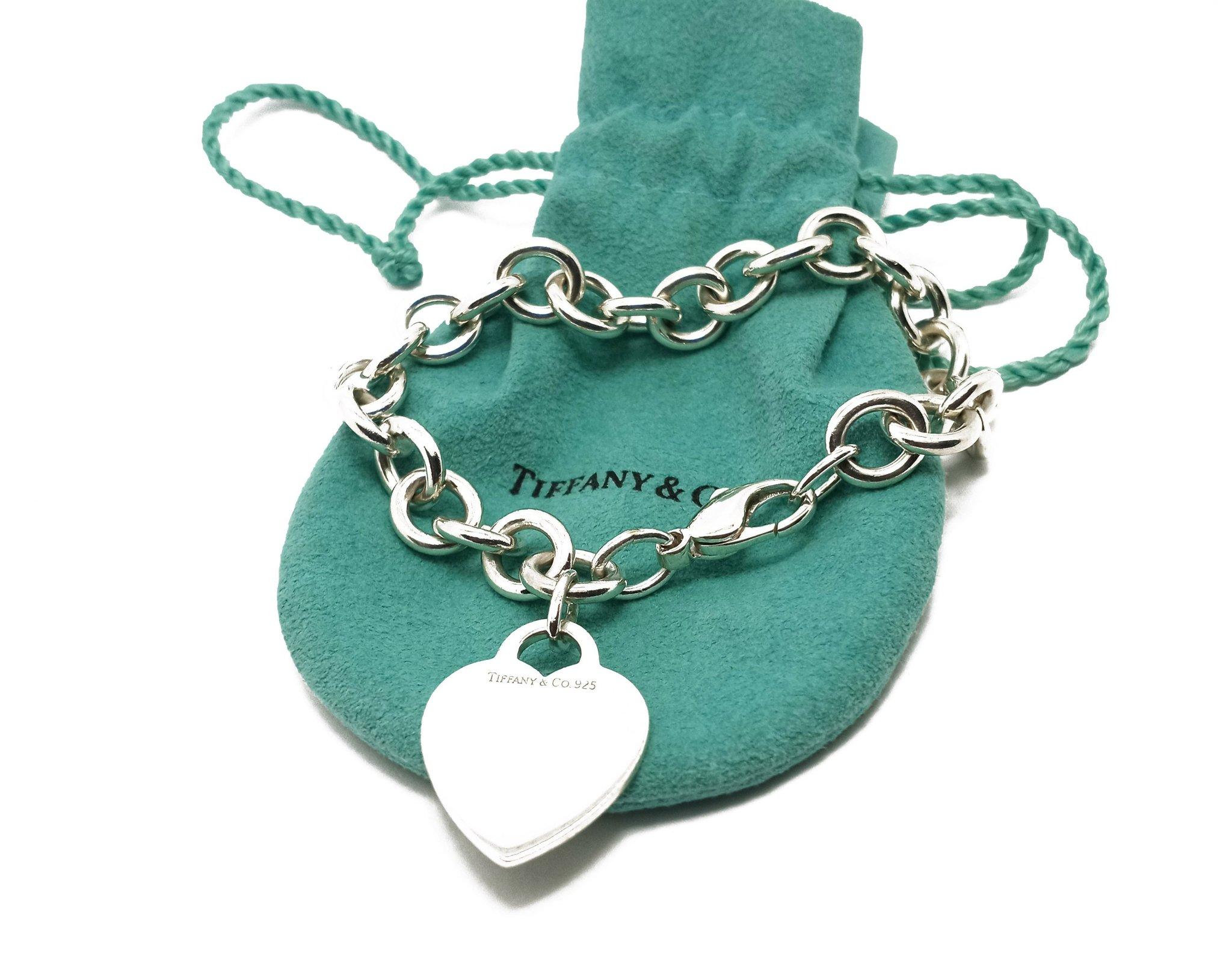 (Item Description)
Brand - Tiffany &Co.
Gender - Unisex
Condition - Pre-Owned 
Style - Heart Charm Bracelet  
Metals - .925 Silver
Weight - 34 Grams
Coating - 24K White Gold
Hall marks - Tiffany &Co. 925
length - 7 1/2 inches
(Tiffany Box & Pouch