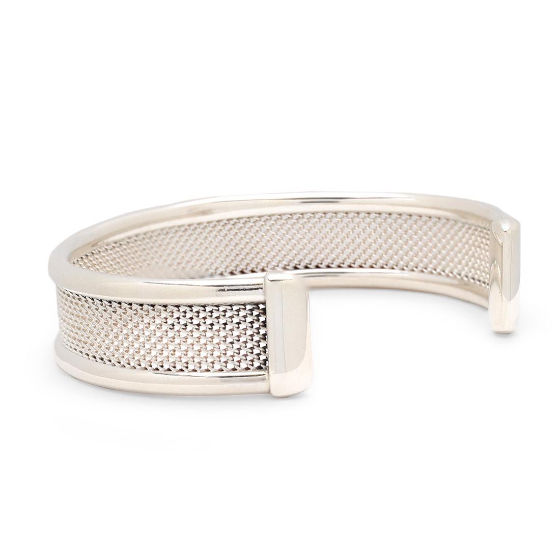 Authentic Tiffany & Co. mesh cuff bracelet crafted in sterling silver. Signed T&Co., 925. The bracelet is presented with the original pouch, no box or papers. CIRCA 1980s.

Bracelet Size: 6 1/4 US
Box: Yes (pouch)
Papers: No