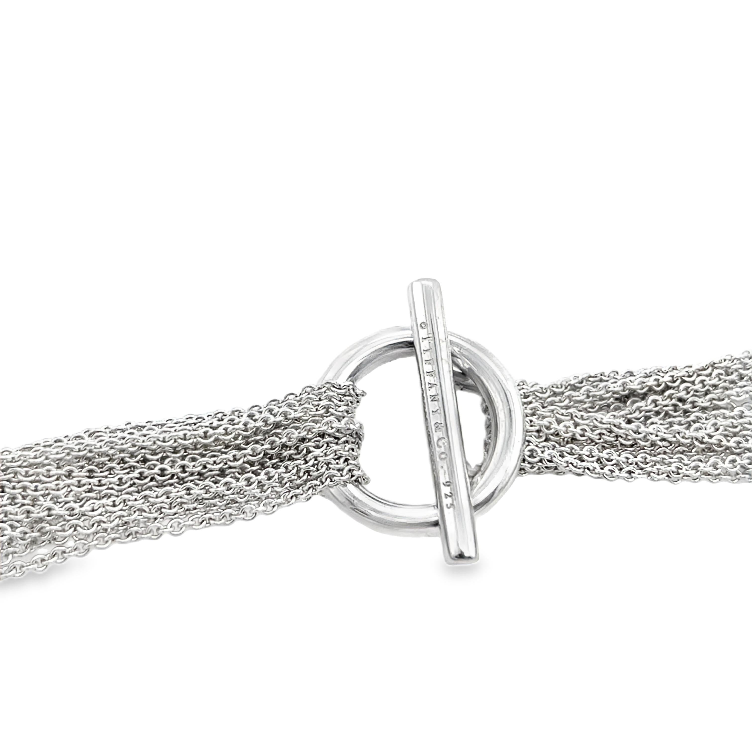 This striking Tiffany & Co. necklace features a bold multi-chain design crafted from high-quality 925 sterling silver. With a total weight of 56.68 grams, this piece offers a luxurious feel and elegant drape, perfect for making a refined yet