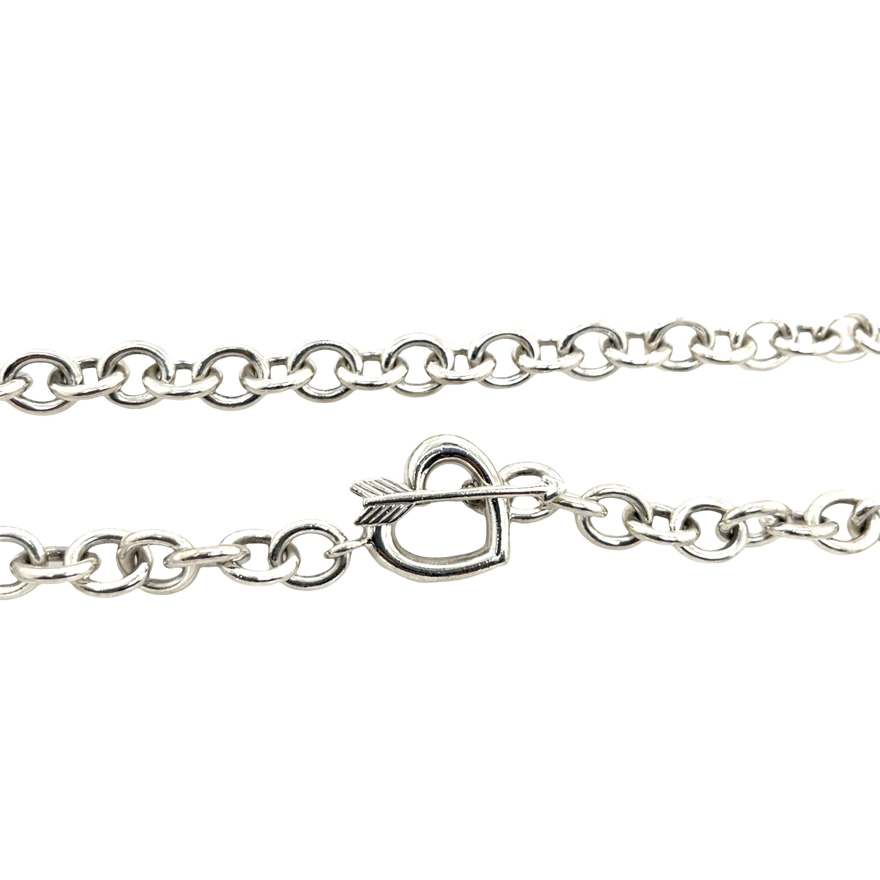 This elegant Tiffany & Co. necklace is crafted from high-polish 925 sterling silver and features a bold heart-shaped clasp. The substantial weight gives the piece a luxurious feel, while the classic Tiffany design ensures timeless appeal. With