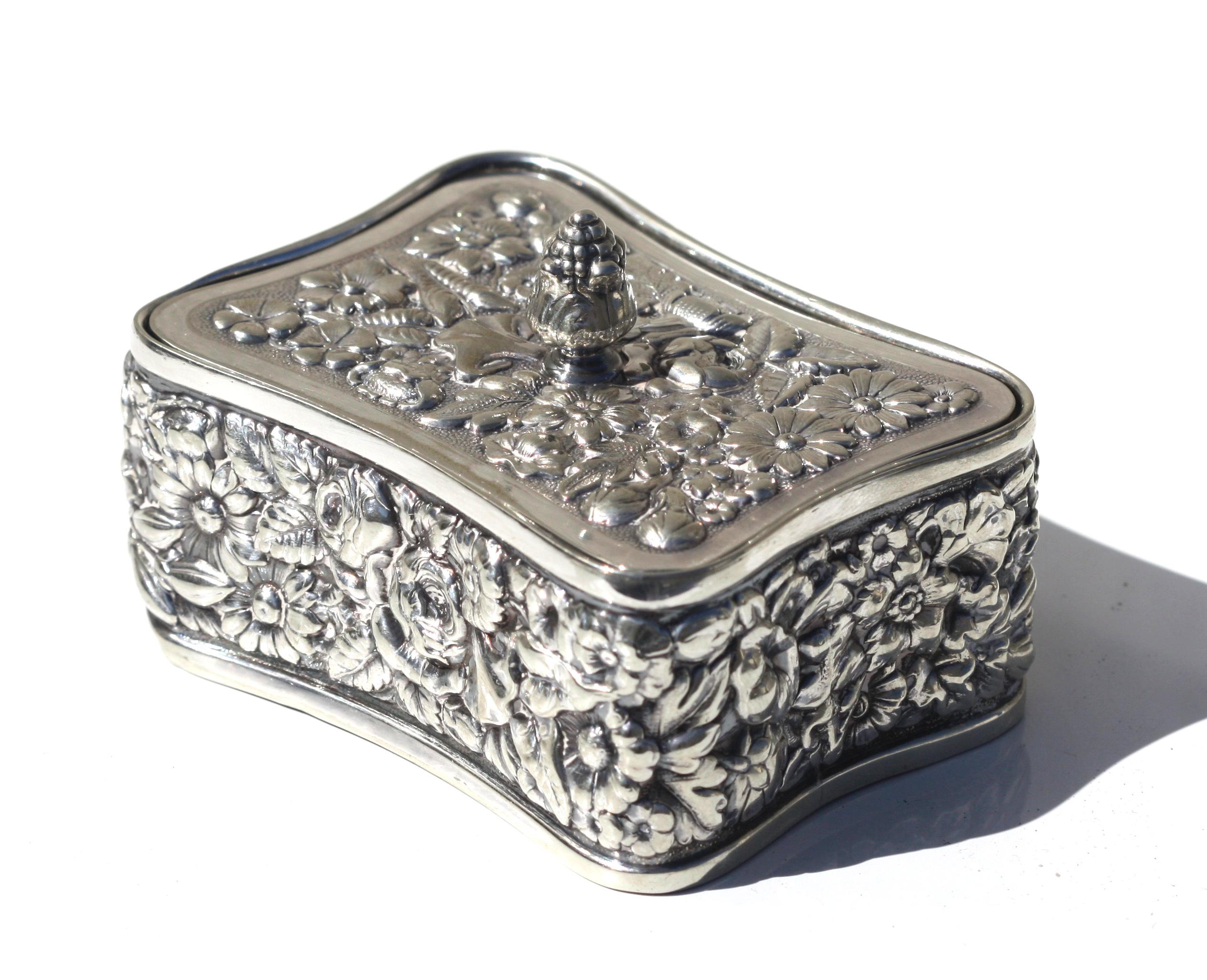 Tiffany & Co. Silver-soldered stamp box and cover.
Early 20th. Century.
Of slightly-curved rectangular form.
3 by 2 1/4 in., Weighted.