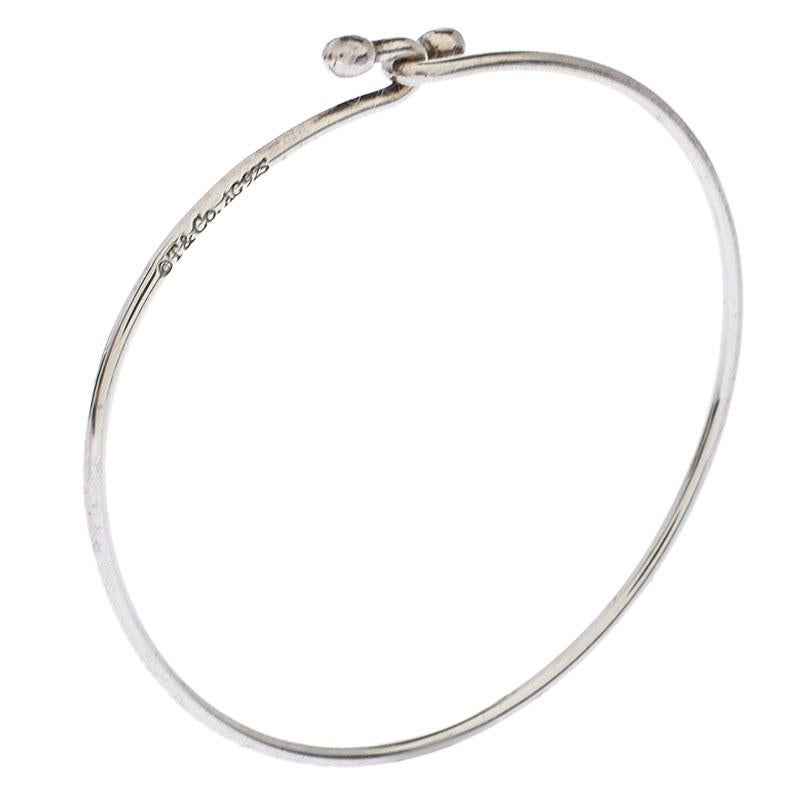 This bracelet from Tiffany & Co. brings the idea of beauty through a simple design. It is beautifully sculpted from silver and the ends are twisted to hook with one another. Boasting a smooth finish, the bracelet will surely be a loved