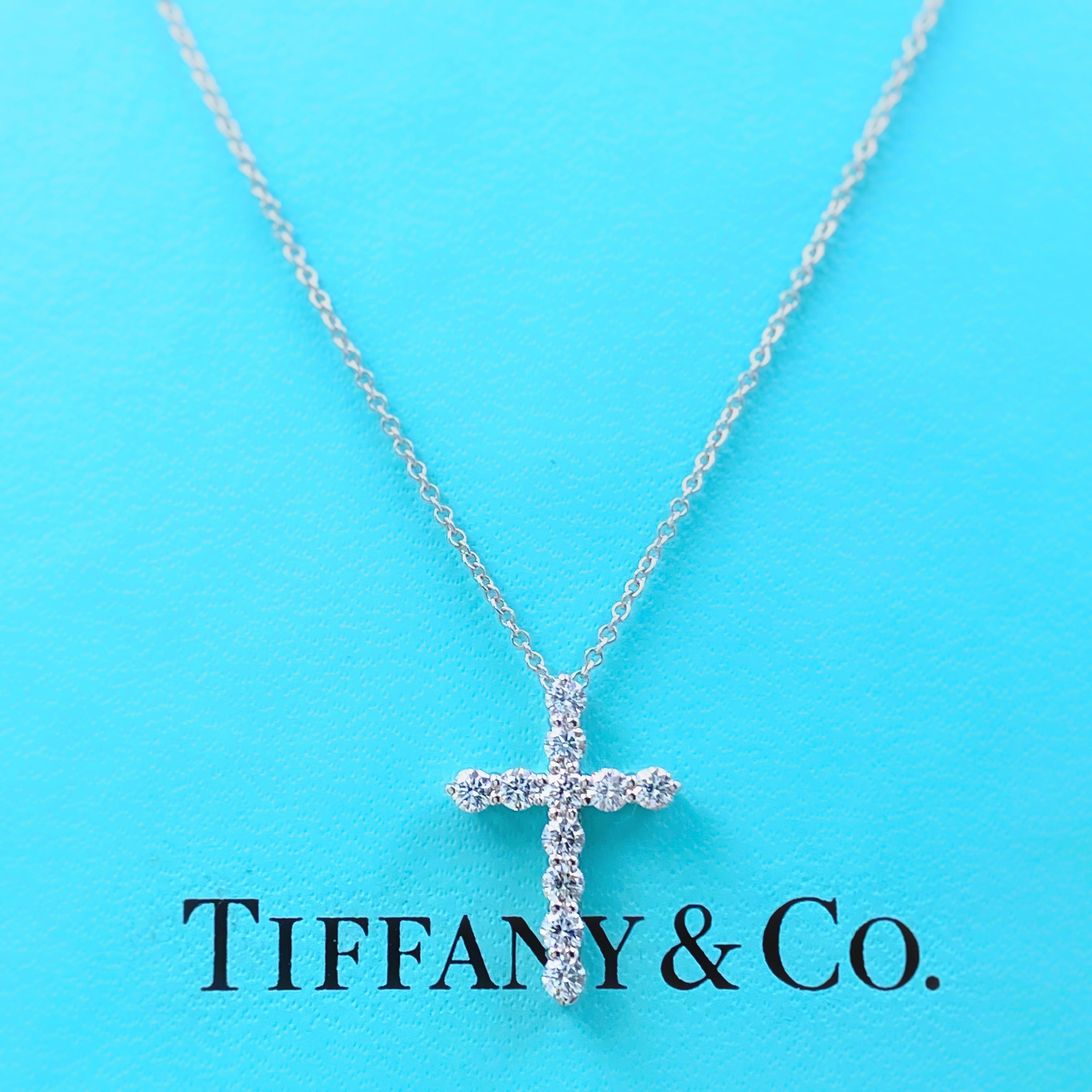 Tiffany & Co Diamond Cross Pendant
Style:  Small
Metal:  Platinum
Size:  16' Chain 
Measurements:  Pendant is .75 X .5 Inches
TCW:  0.47 tcw
Main Diamond:  11 Round Brilliant Cut Diamond
Color & Clarity:  G - VS1
Hallmark:  PT950